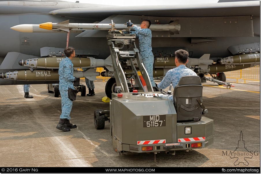 AFEs load an AIM-9X on an F-15SG as part of the Arming Demonstration preview