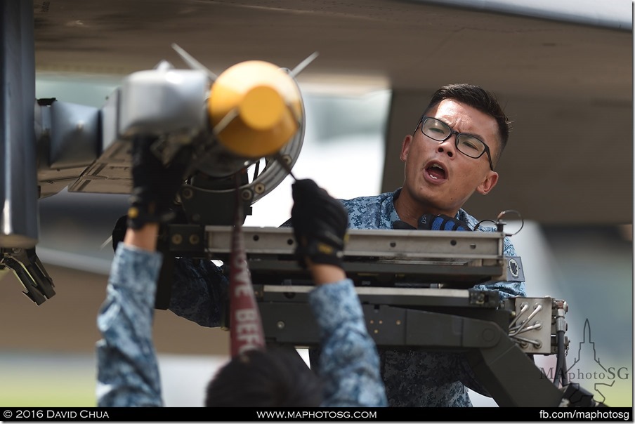 AFEs load an AIM-9X on an F-15SG as part of the Arming Demonstration preview