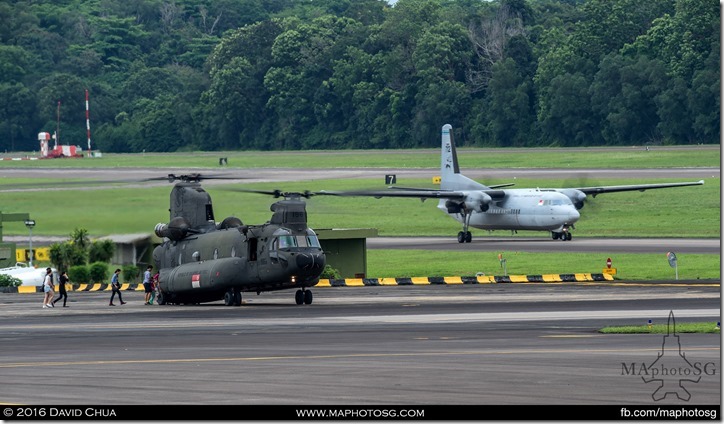 Joyride participants boarding a CH-47D Chinook while a Fokker 50 taxies for take off.