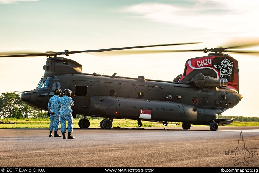 NDP State Flag flypast: RSAF Ground crew watches as the CH-47D Chinook moves into position for hook up