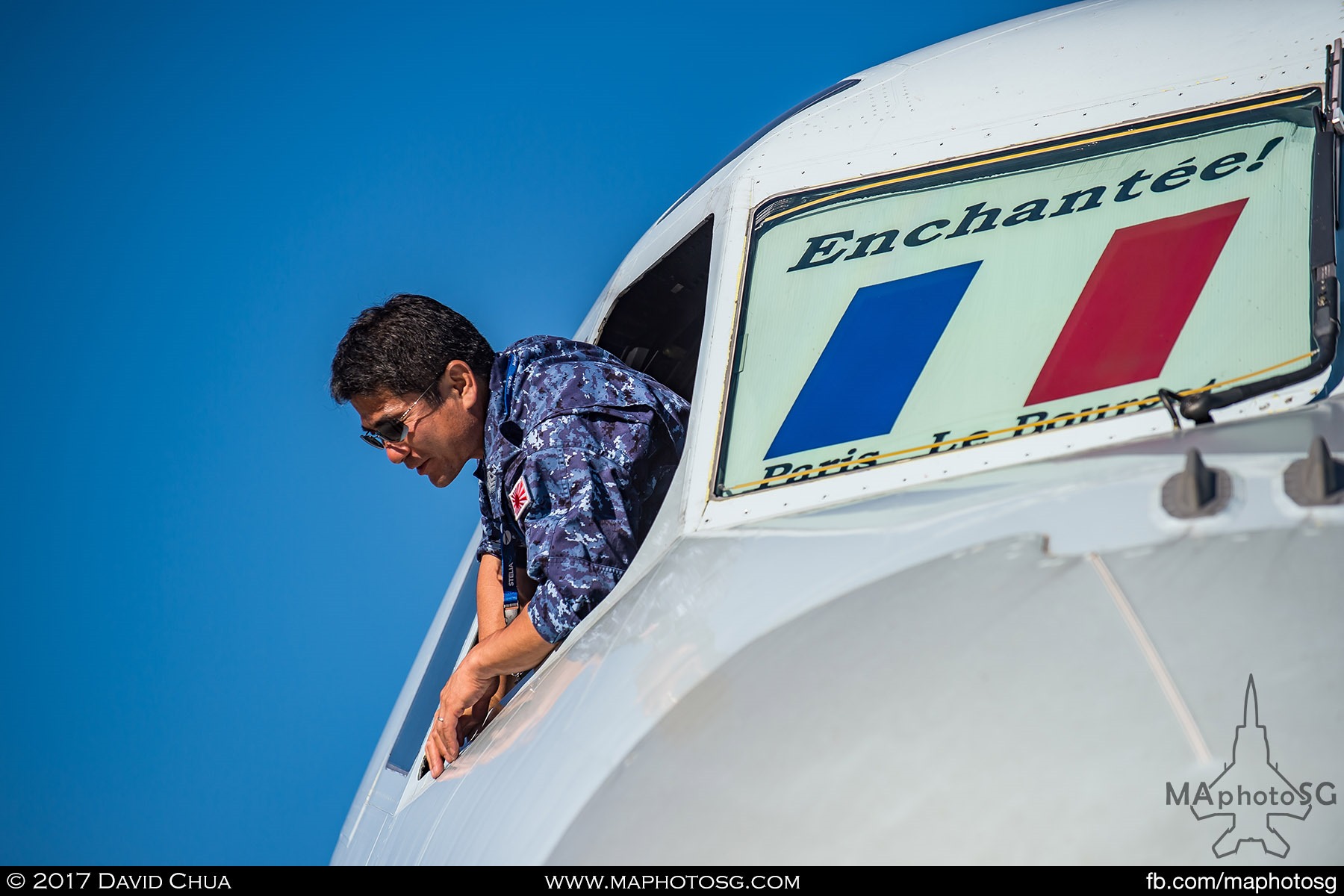 9. A crew member of the JMSDF Kawasaki P-1 MPA looks down from the cockpit of the aircraft.