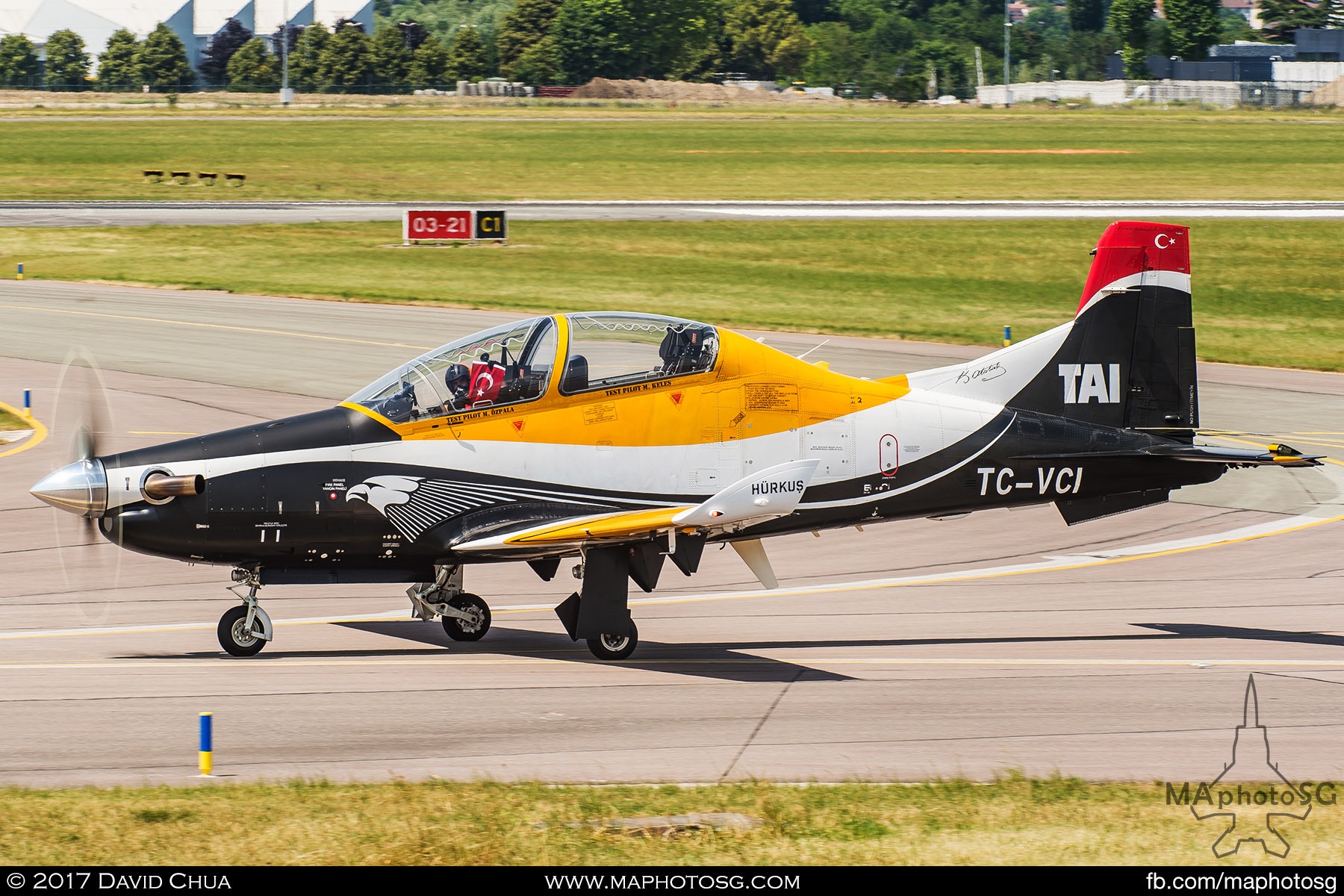 29. Test pilot Murat Keles, a former Turkish Air Force F-16 pilot holds up the Turkish flag as the TAI HÜRKUŞ he was flying taxis back after his six minutes of amazing performance. This is also the first time TAI demonstrated the HÜRKUŞ in an international air show.