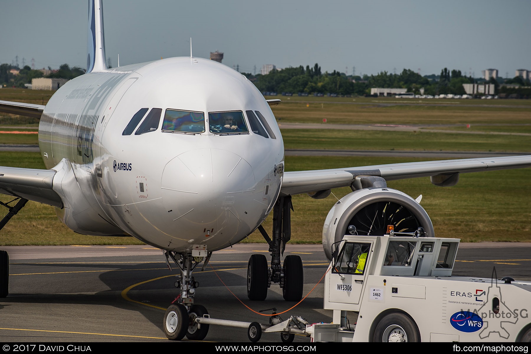 35. Pilot of the Airbus A320neo looks on as the aircraft is towed back to the Static Display Area.