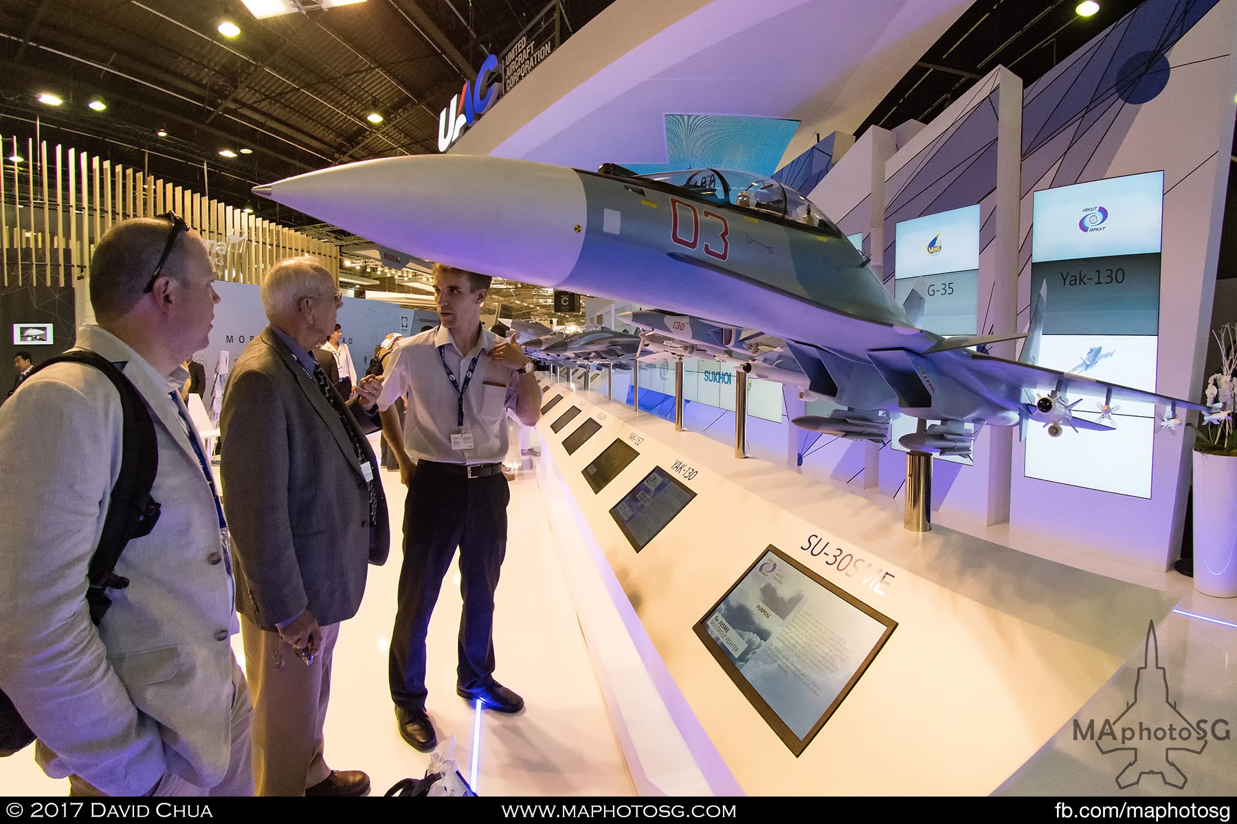 17. A representative from the United Aircraft Corporation explains the details of the SU-30SME to two interested gentlemen.