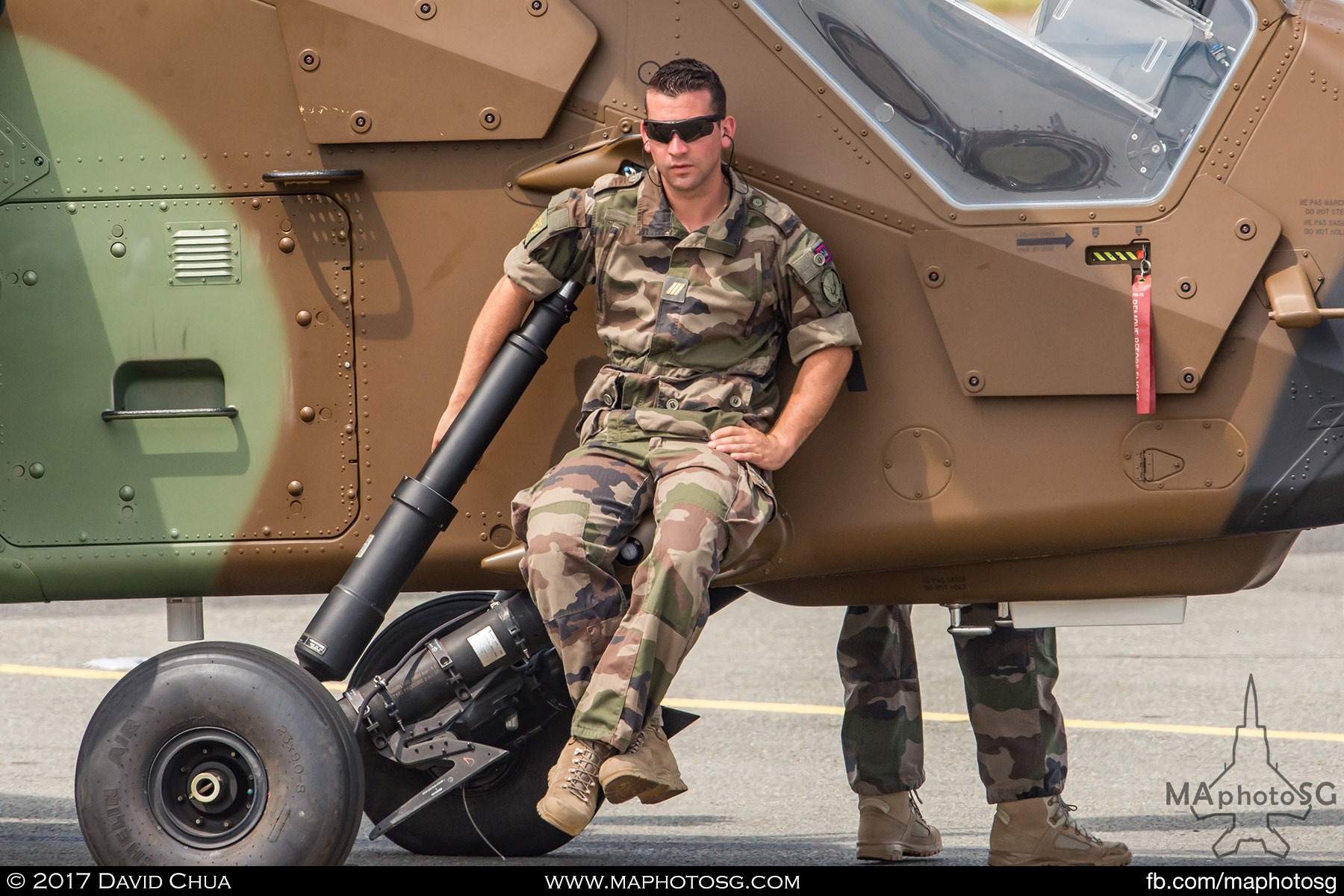 37. Crew of the Airbus Helicopter Tiger relaxes as the aircraft is towed out for it’s aerial display.