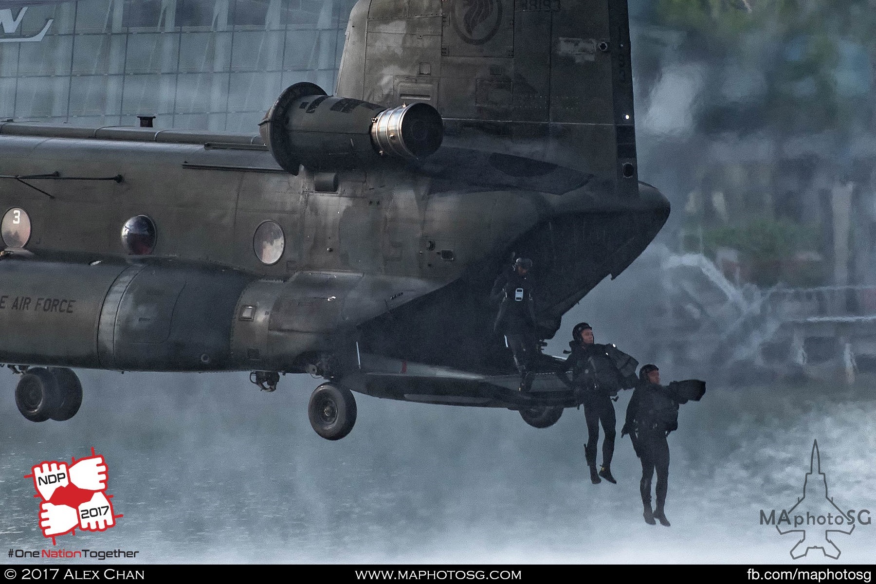 12. Navy Divers inserting into the water from the CH-47D Chinook’s ramp.
