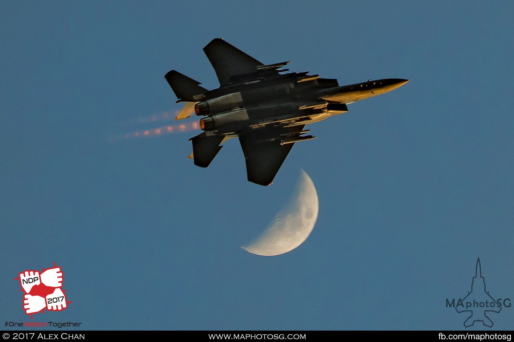 23. A single F-15SG passes the moon after the Salute to the Nation.
