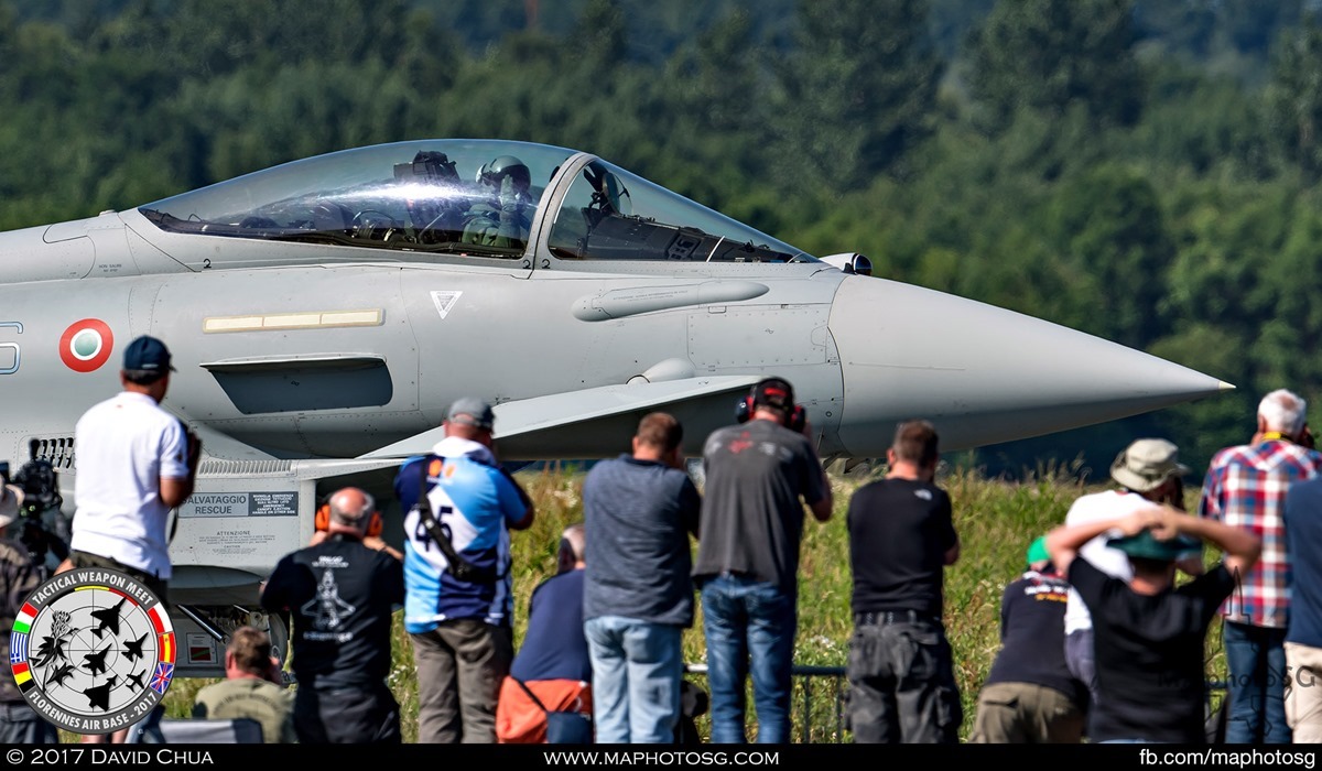 29. Pilot of the Italian Air Force Eurofighter Typhoon from 4° Stormo waves to the line of photographers as he taxis pass.