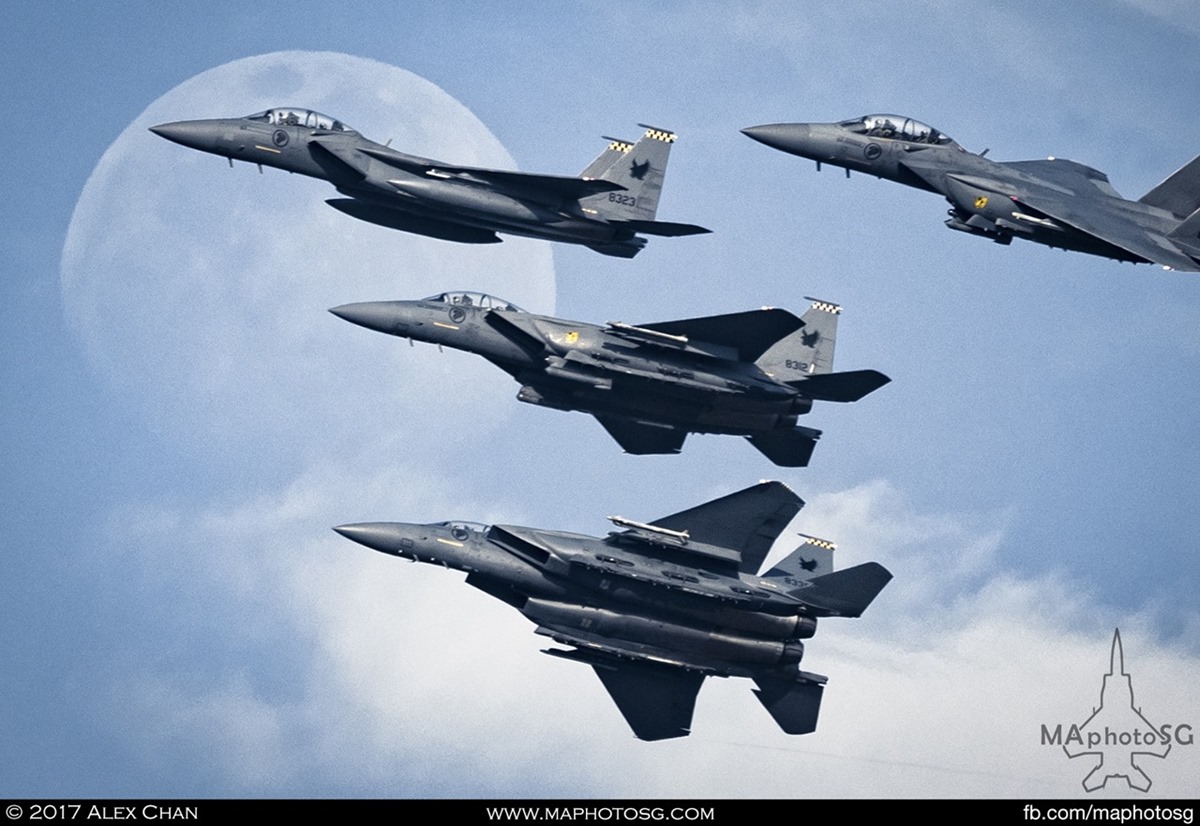 Moon rises behind a flight of RSAF F-15SG Strike Eagles as they practice for NDP 2017