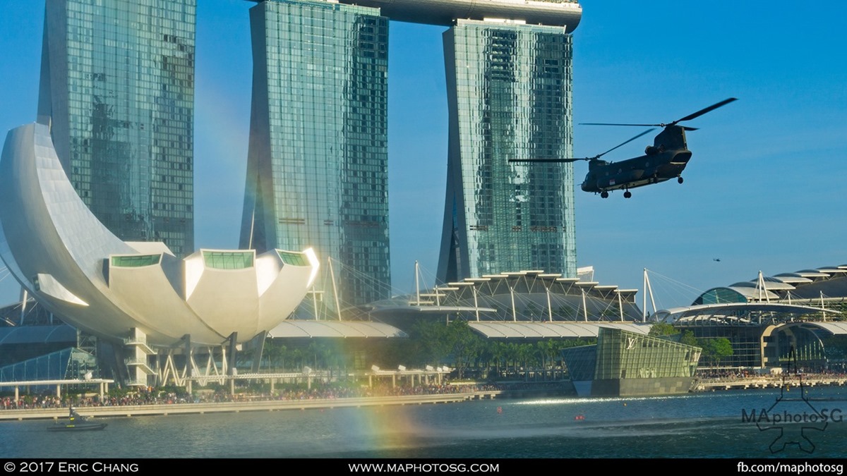 A rainbow is formed by the water mist created by the Chinook during ndp rehearsal