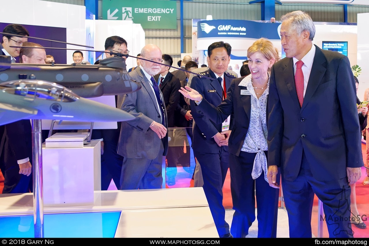 Leanne Caret of Boeing hosts Defence Minister Ng Eng Hen and Chief of Air Force Mervyn Tan at the Boeing booth