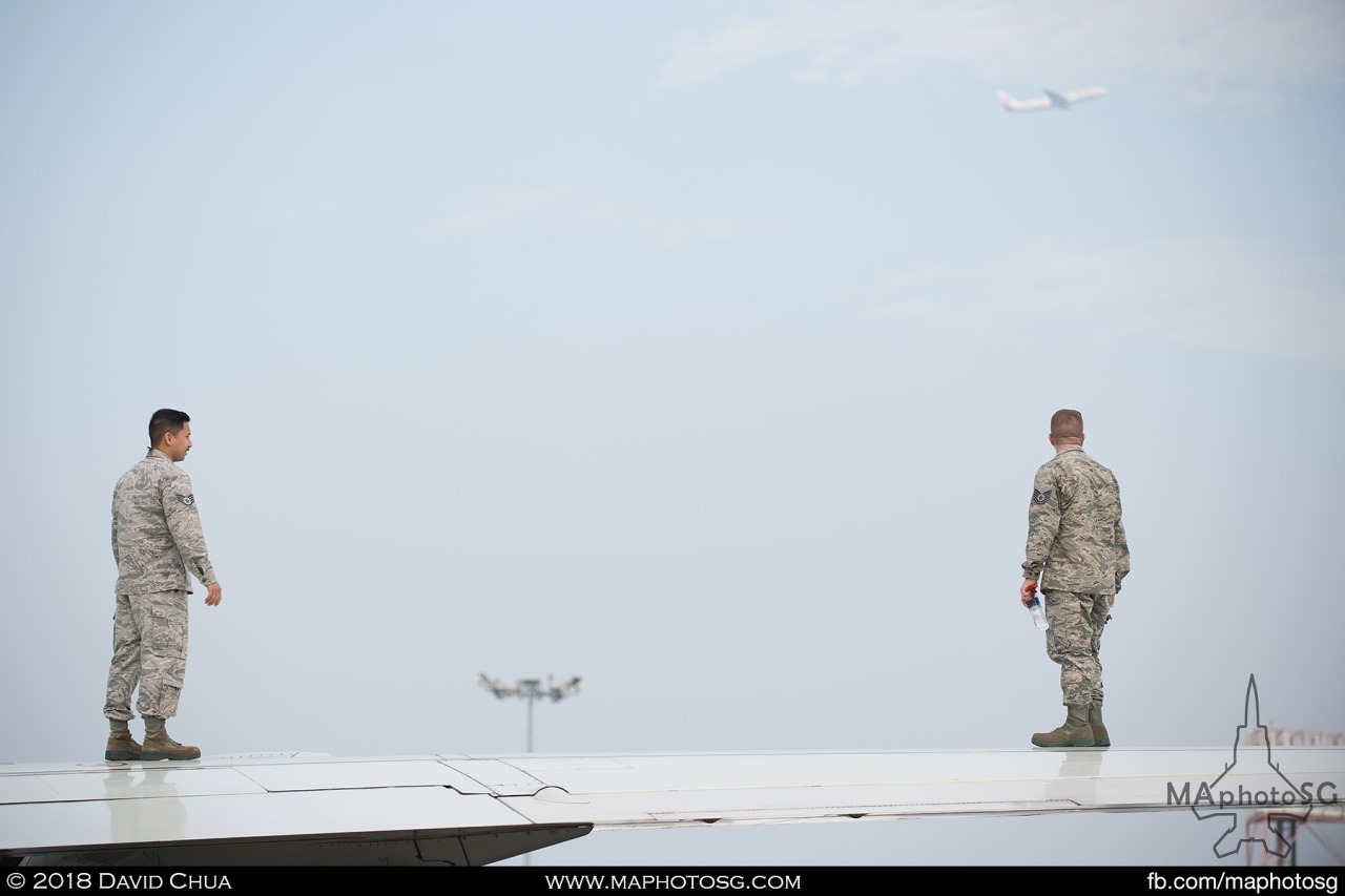 Crew of USAF E-3B Sentry inspecting the wings