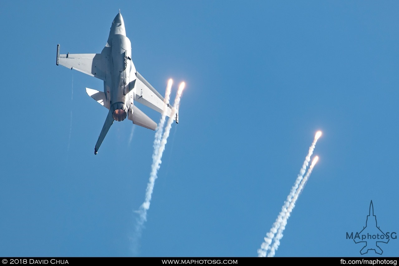 USAF F-16C releases flares as it goes vertical