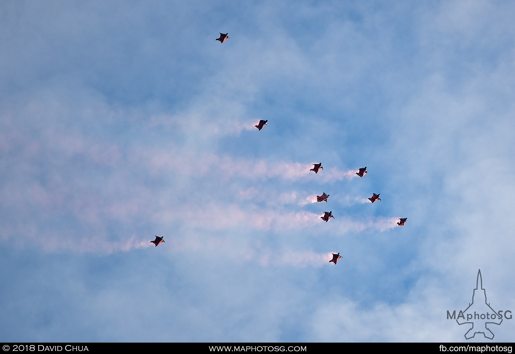 08. Red Lions fly into Marina Bay area in their wingsuits from 3800m trailing red smoke.