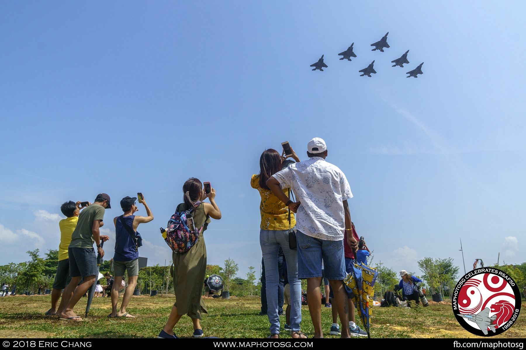 Spectators at the waterfront near Marina Barrage captures the F-15SGs with their mobile phones as the they fly past in Delta Formation.