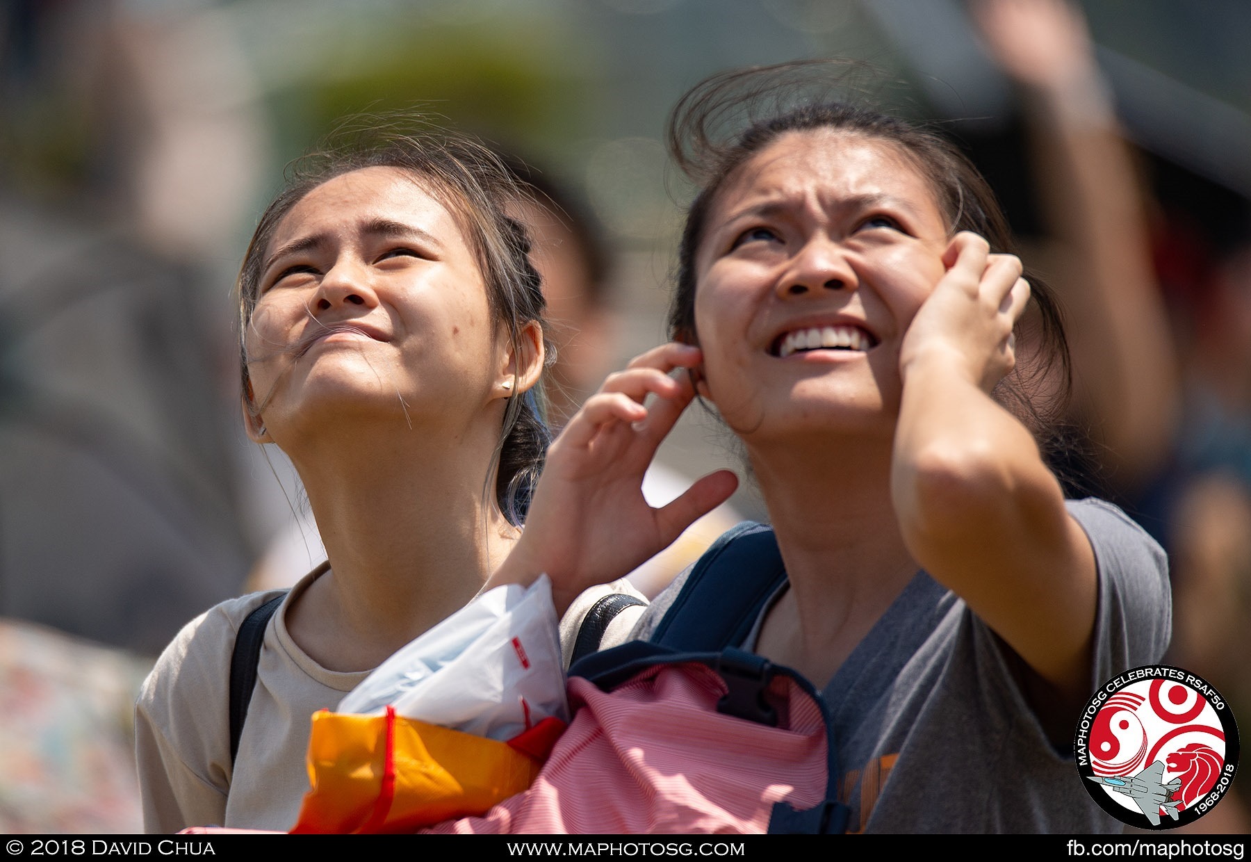 Spectators look up as the Fighter Aerial Display begins with the sound of freedom.