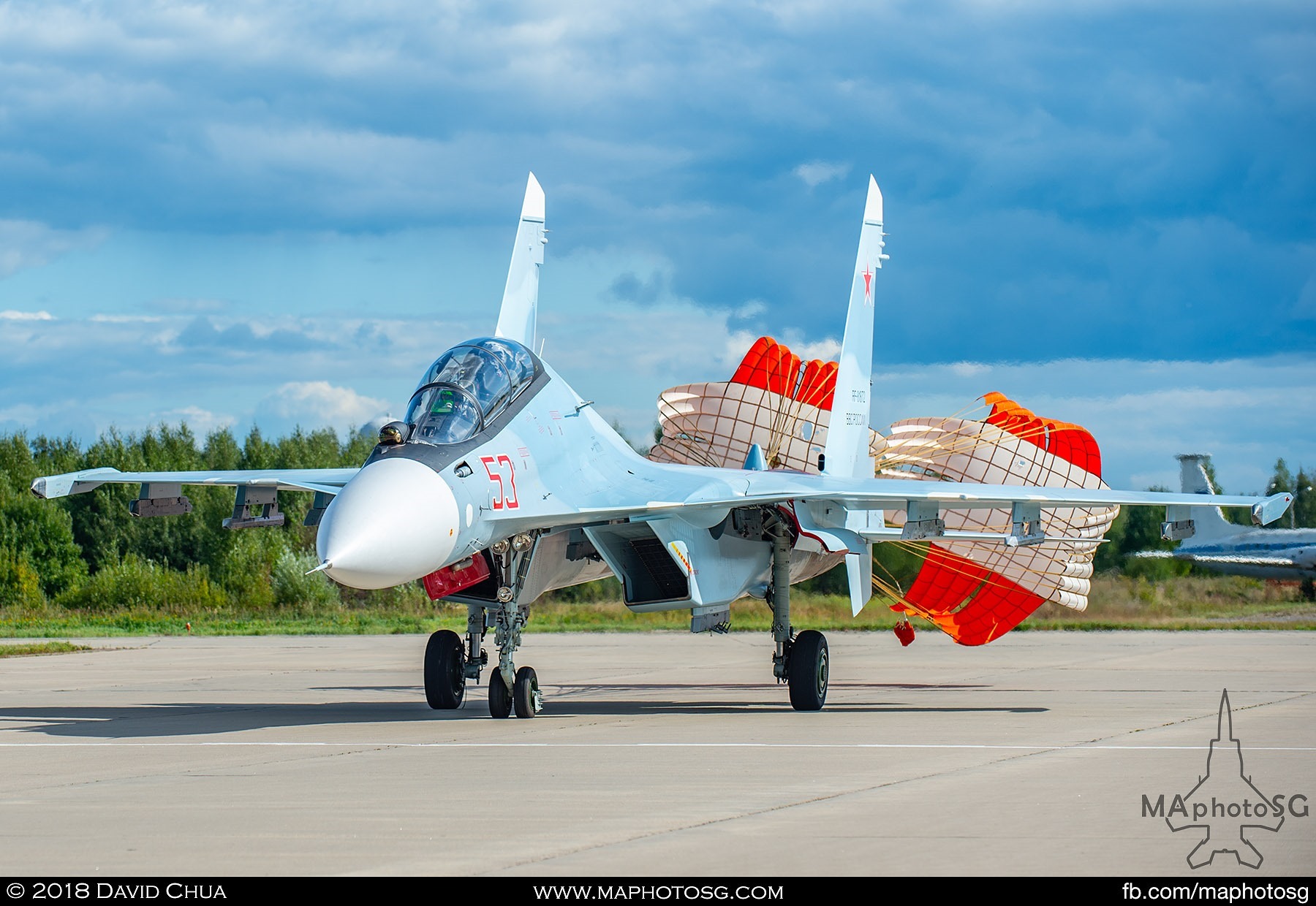 42. Chutes deployed as the Su-30sm "Flanker" turns of the runway after landing