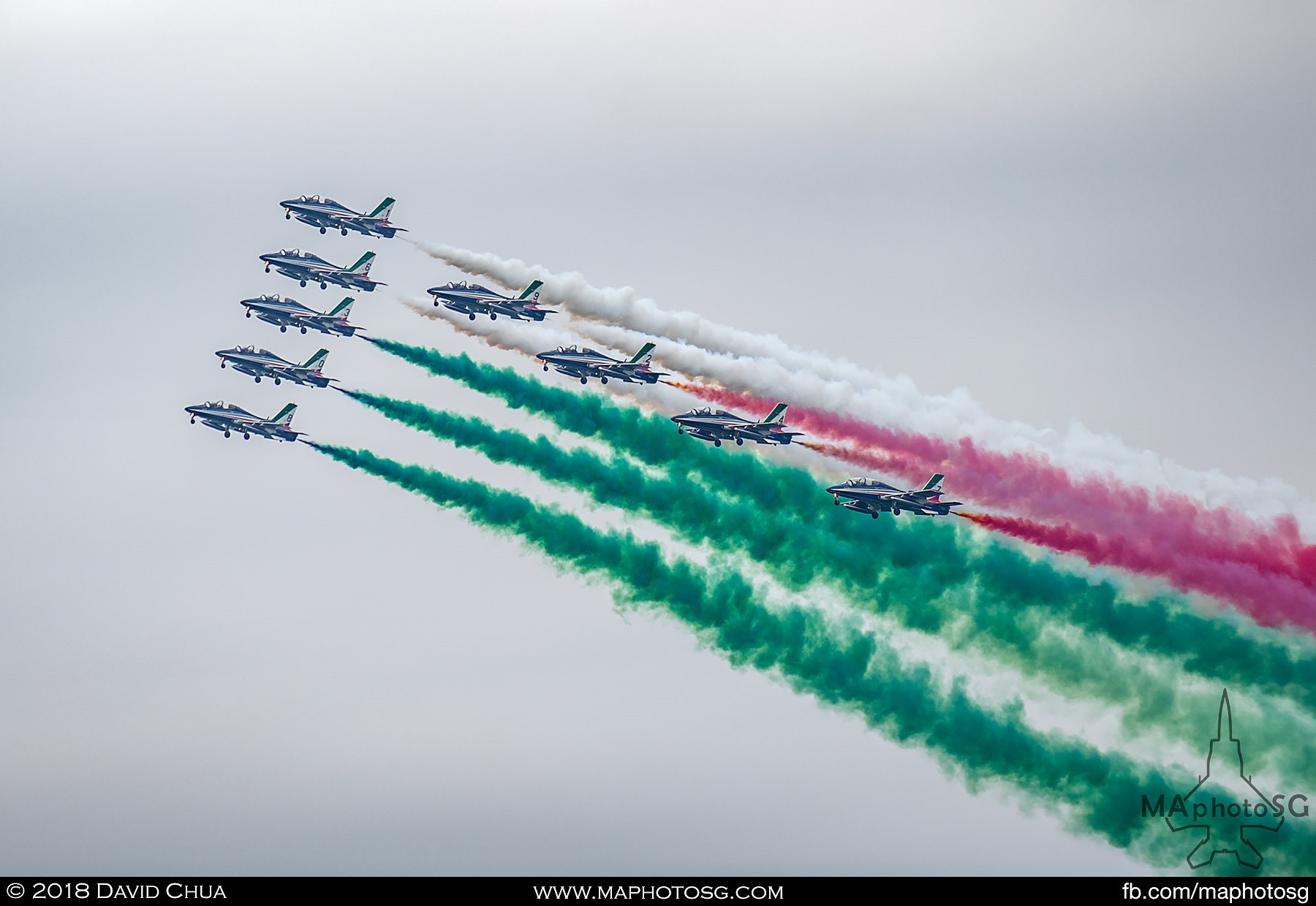 57. Frecce Tricolori flying in formation and painting the sky with the green white and red of the Italian Flag