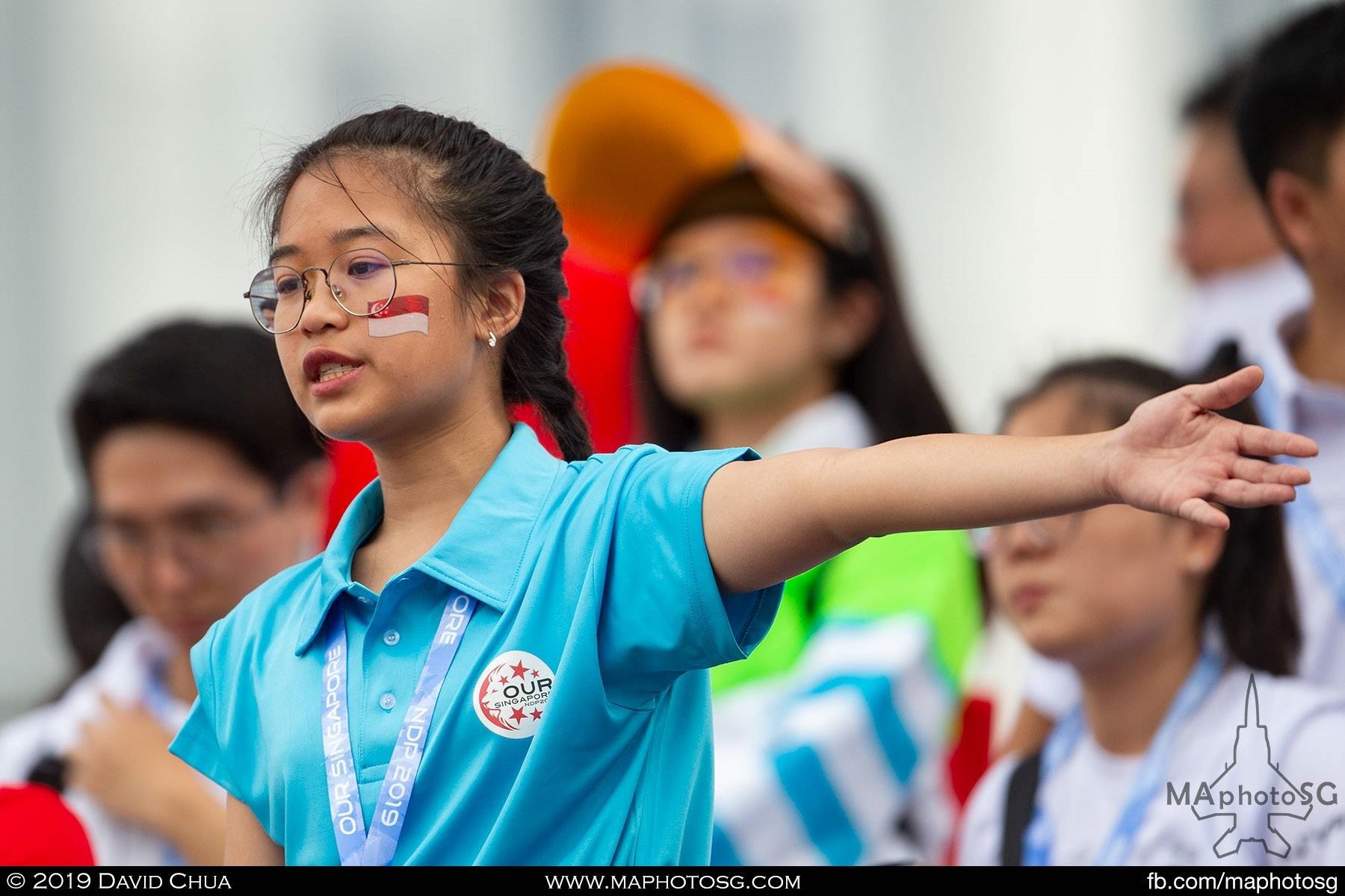 One of the many ushers helping the spectators find their seats