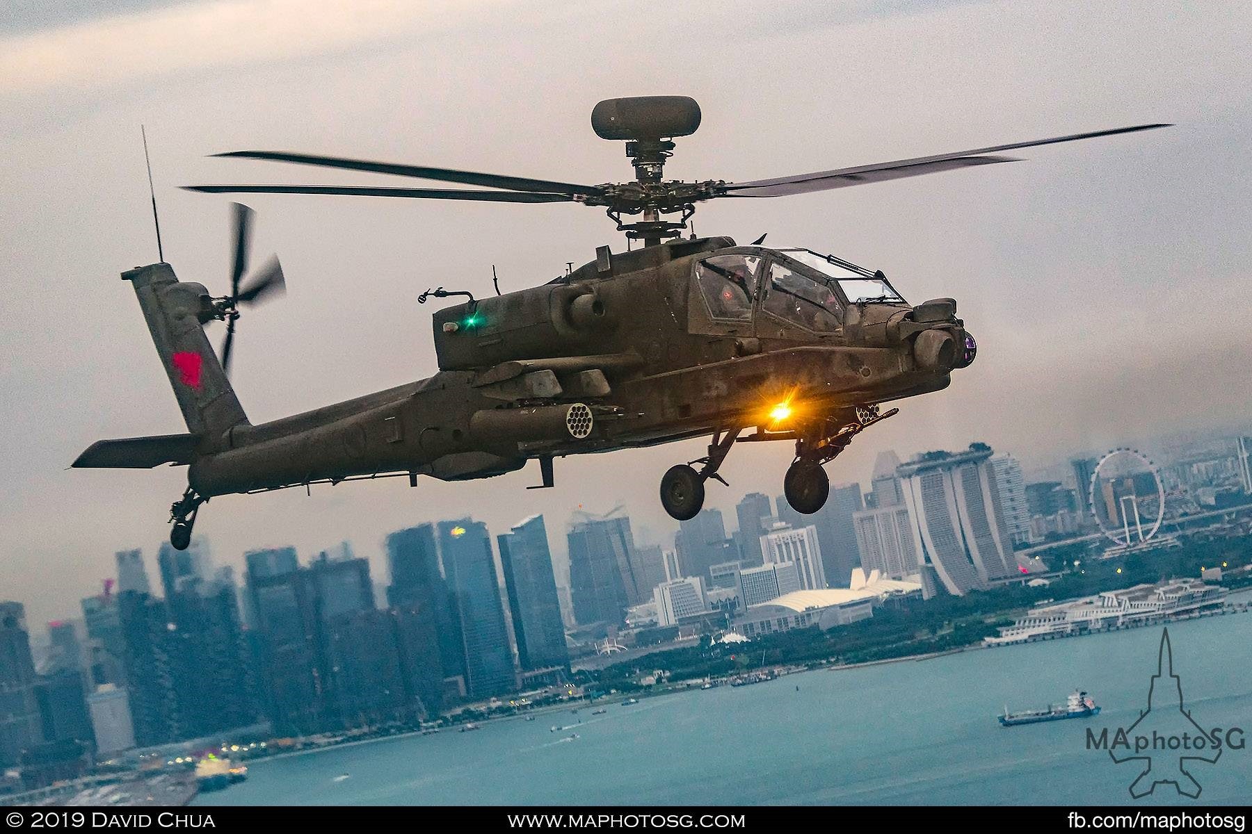 RSAF AH-64D Longbow Apache helicopter flying in formation with the flag flying Chinook.
