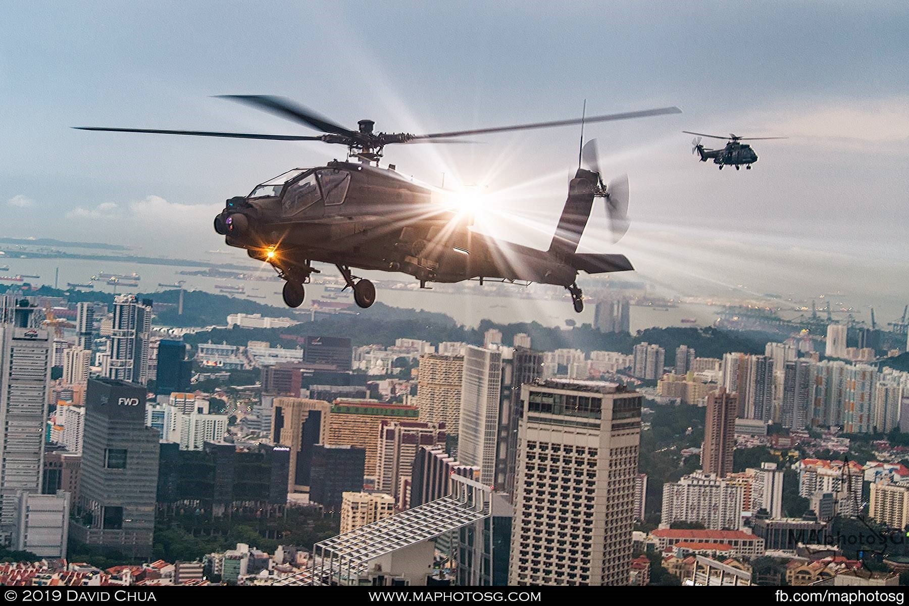 RSAF AH-64D Apache and Super Puma helicopters flying over the CBD 