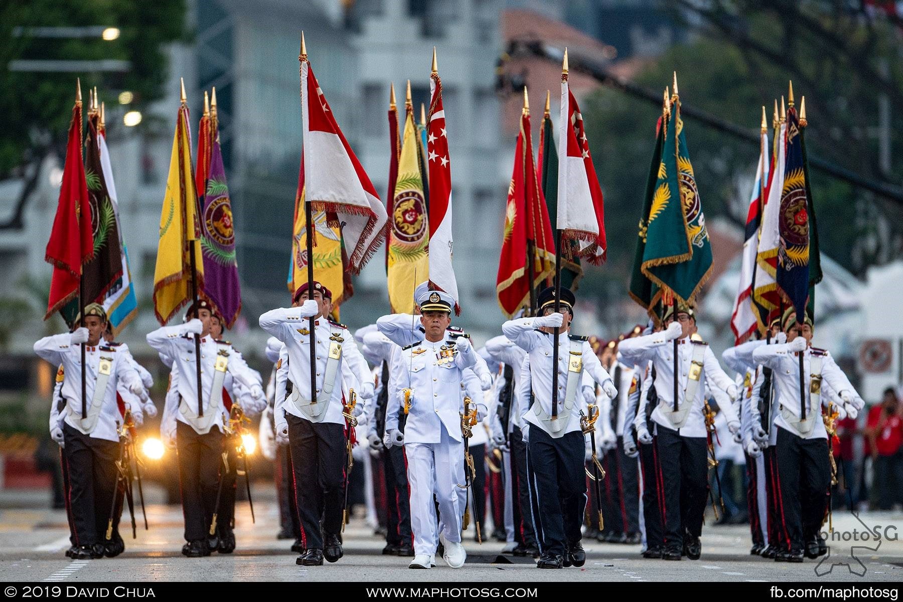 Parade Commander, LTC Alvin Choo, Commander of Operations Group, Naval Diving Unit leads the parade march past with the SAF Colours Party