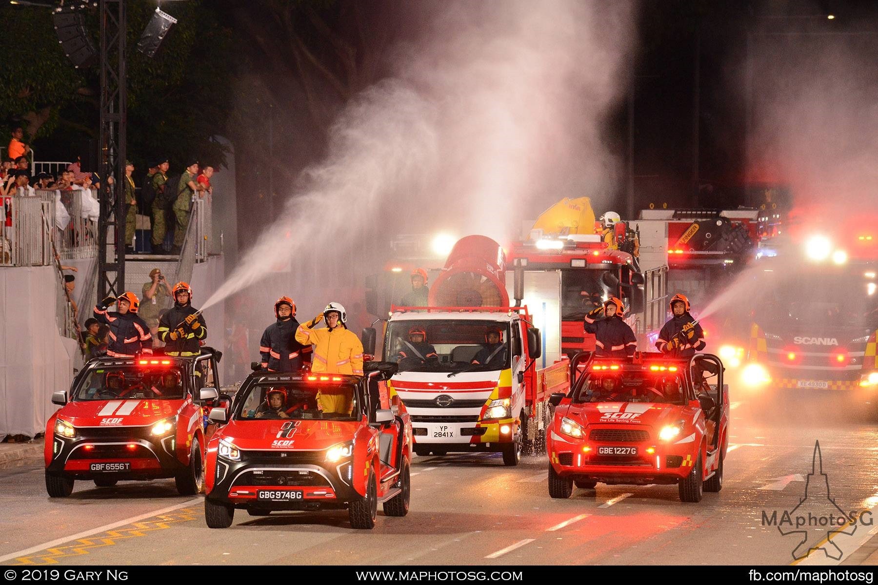 Civil Defence firefighting vehicles giving the spectators a spray