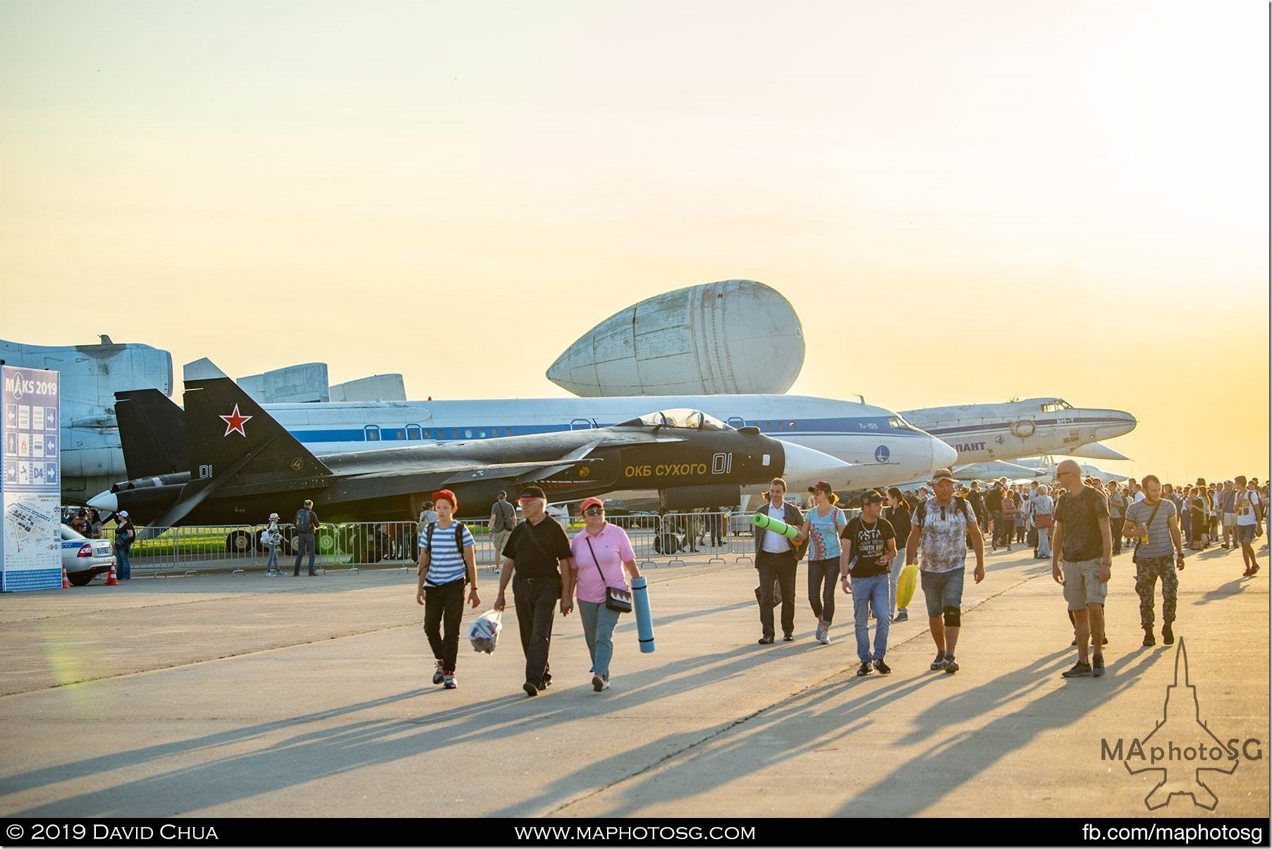 Visitors leave the airshow as the sun sets at Zhukovsky Airport