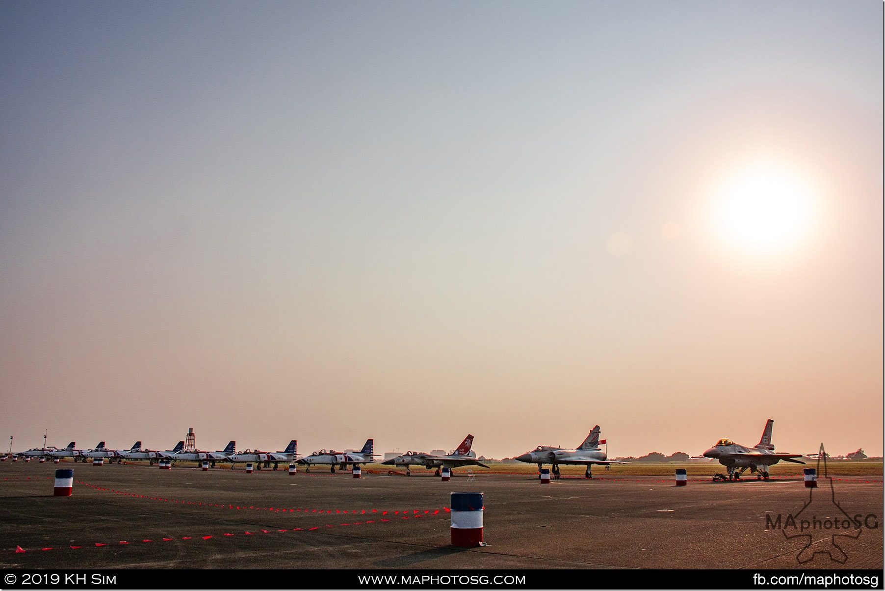 Flight line of aerobatic display aircraft as the sun sets