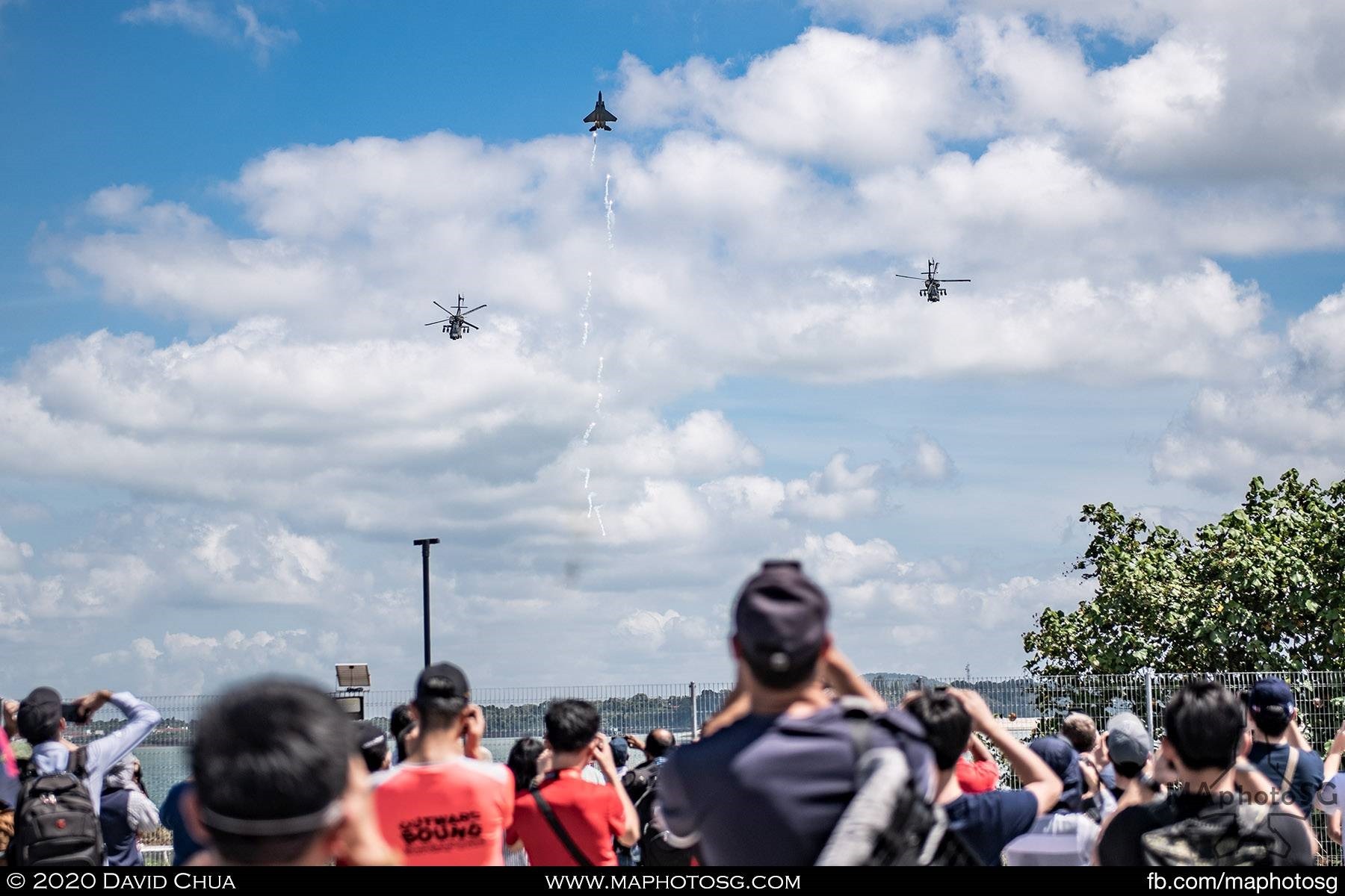 To express their appreciation for the audience, the two AH-64Ds bow together with the F-15SG performing a vertical spiral climb, with a column of flares to close the show