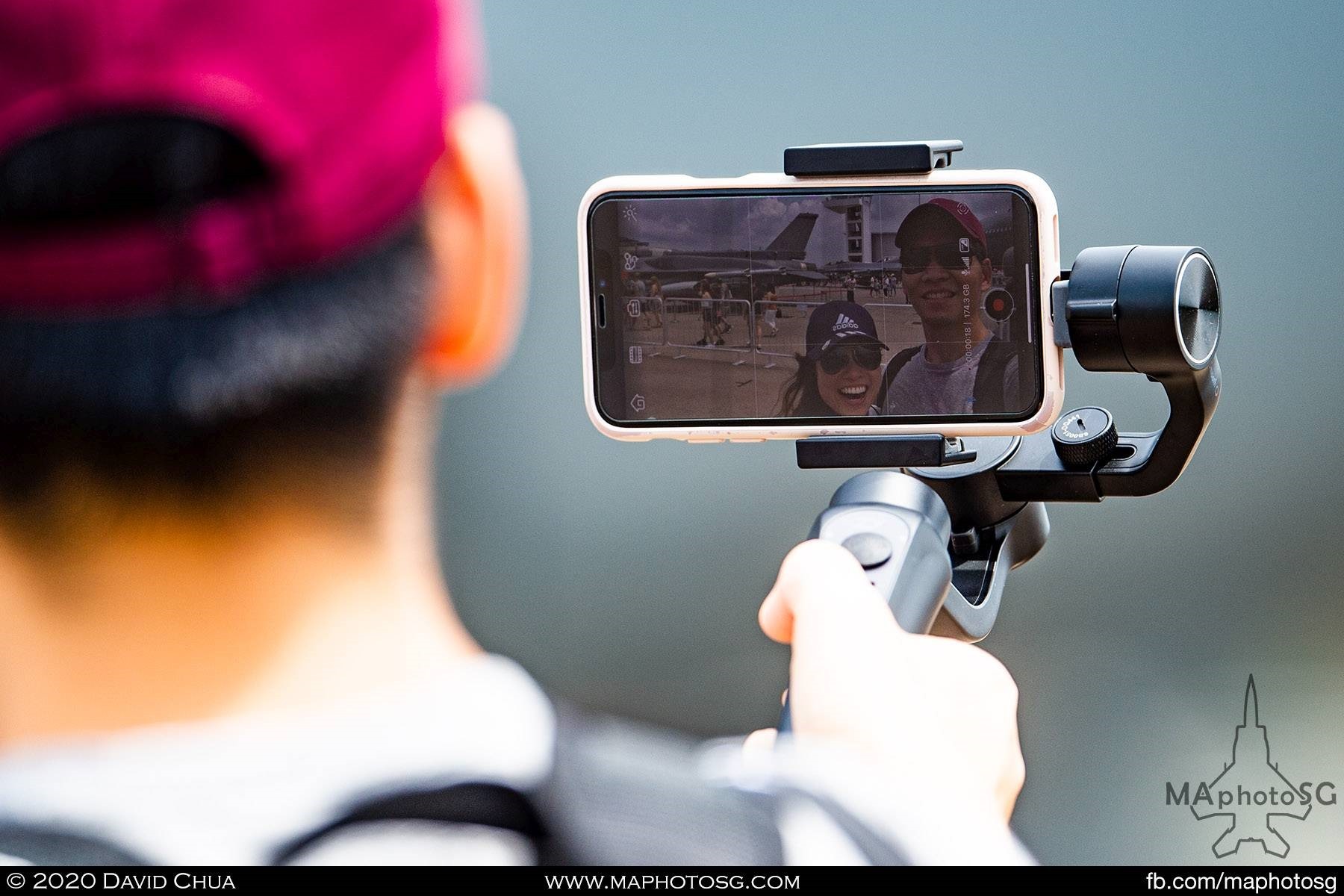 A couple doing a 360 degree wefie on their phone