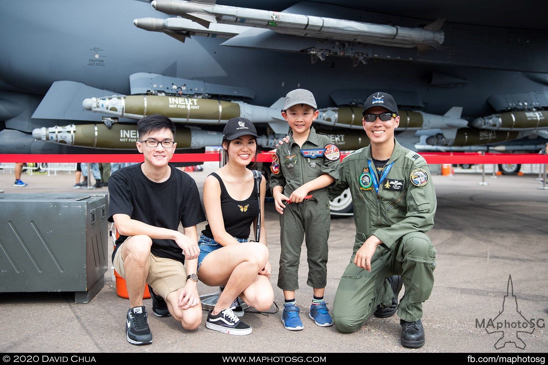 Visitors pose for photo with the pilot of the F-15SG