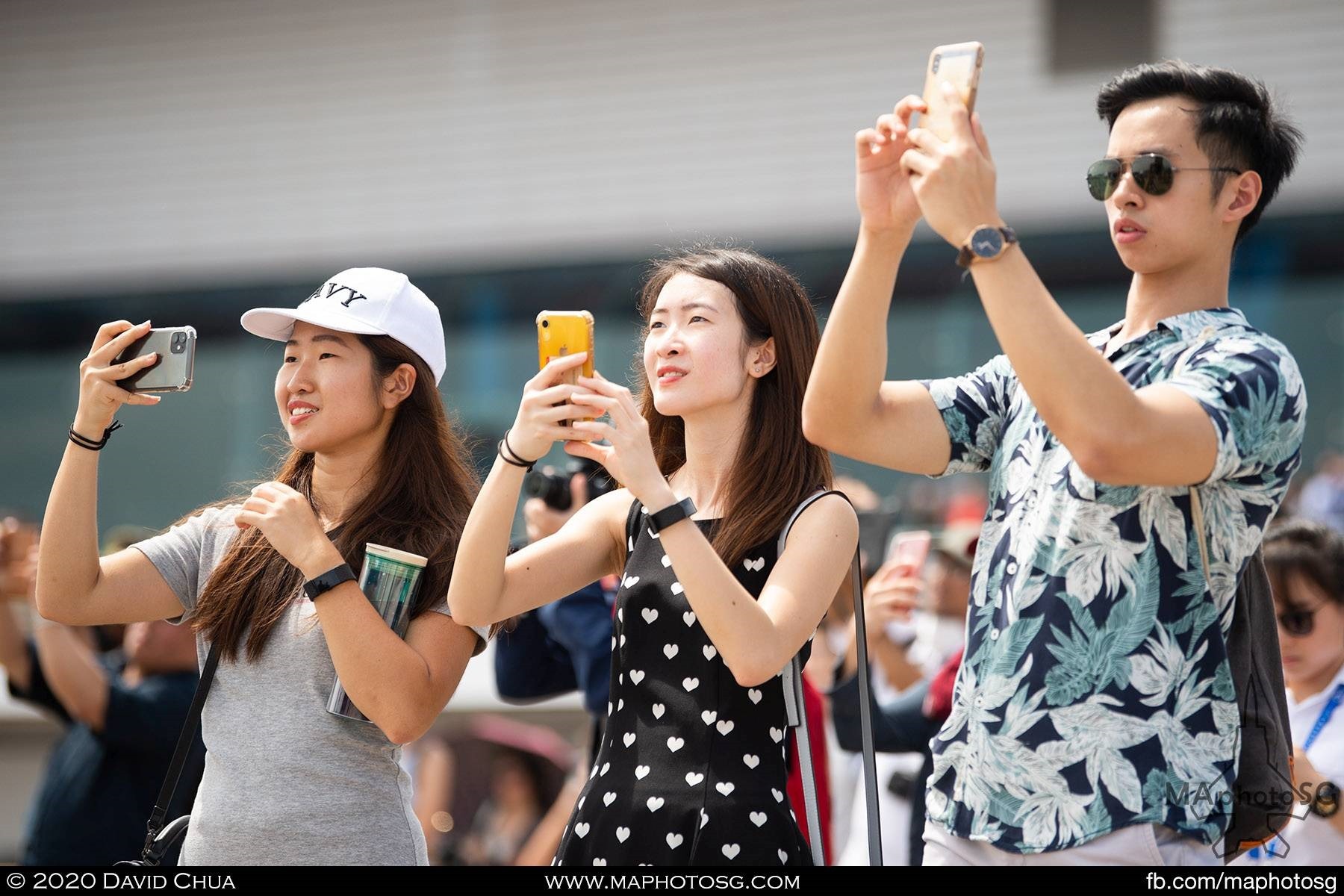 Spectators recording the aerial display on their mobile phones
