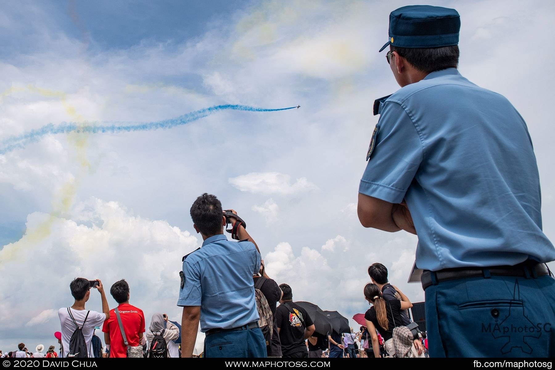 Members of the PLAAF watch on as the Ba Yi Aerobatics Team entertains the crowd