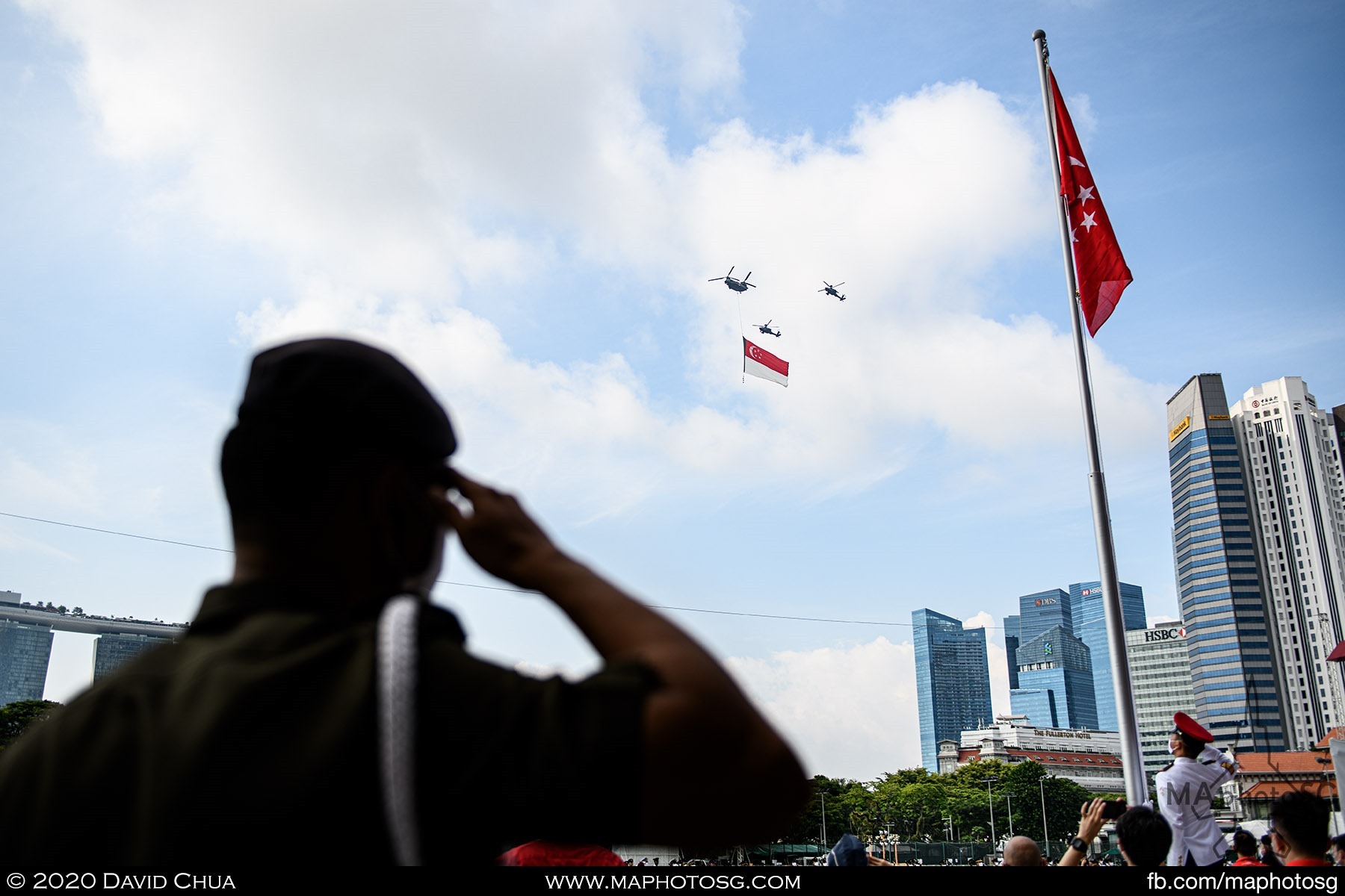 National Anthem moment at Padang as the State Flag flies over the parade.