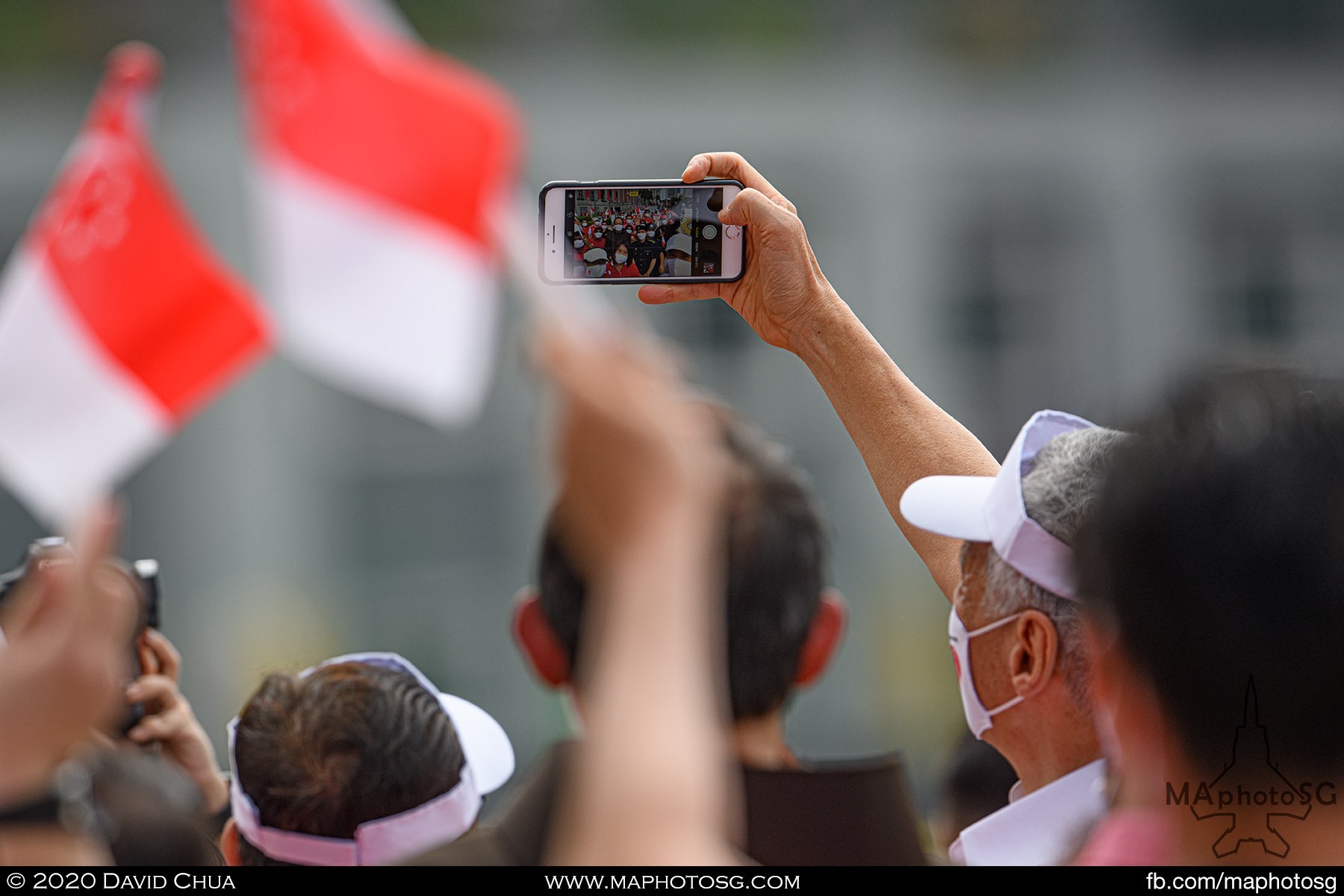 Prime Minister Lee Hsien Loong takes a wefie with spectators at the end of the Parade@Padang.