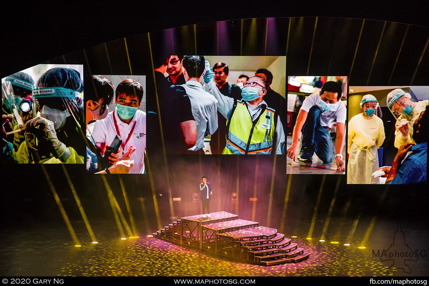 Umar Sirhan sings "Everyday Heroes", composed by Dick Lee, against a backdrop montage of frontline fighters and essential services workers.