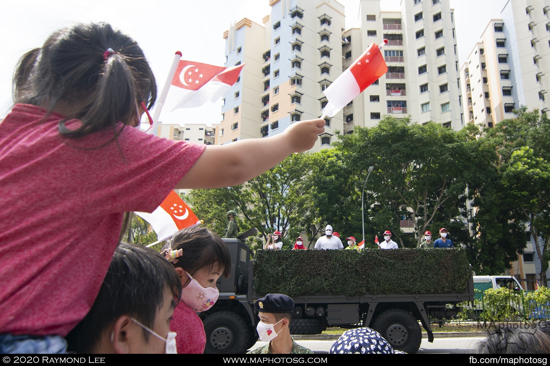 Spectators cheer the frontline fighters and essential services workers in the Mobile Column.