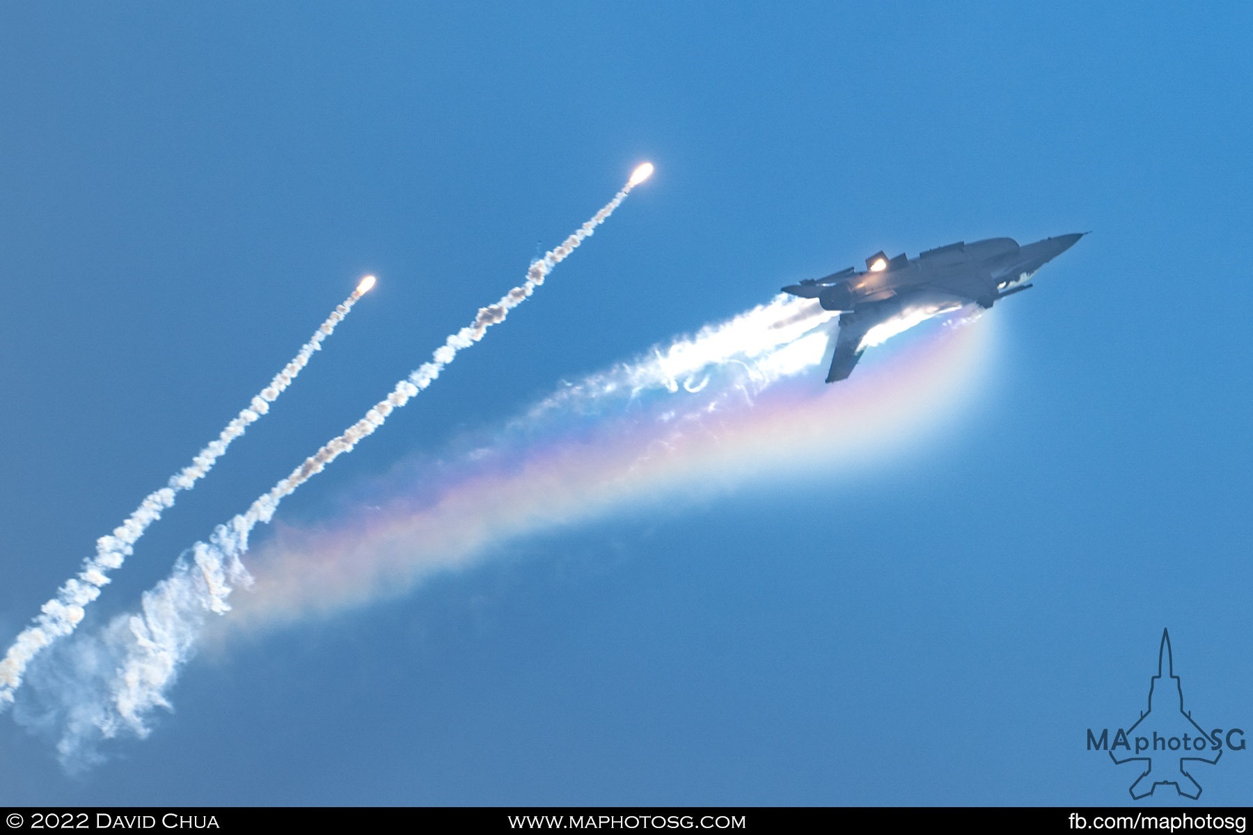 RSAF F-16C Viper popping flares and generating a rainbow