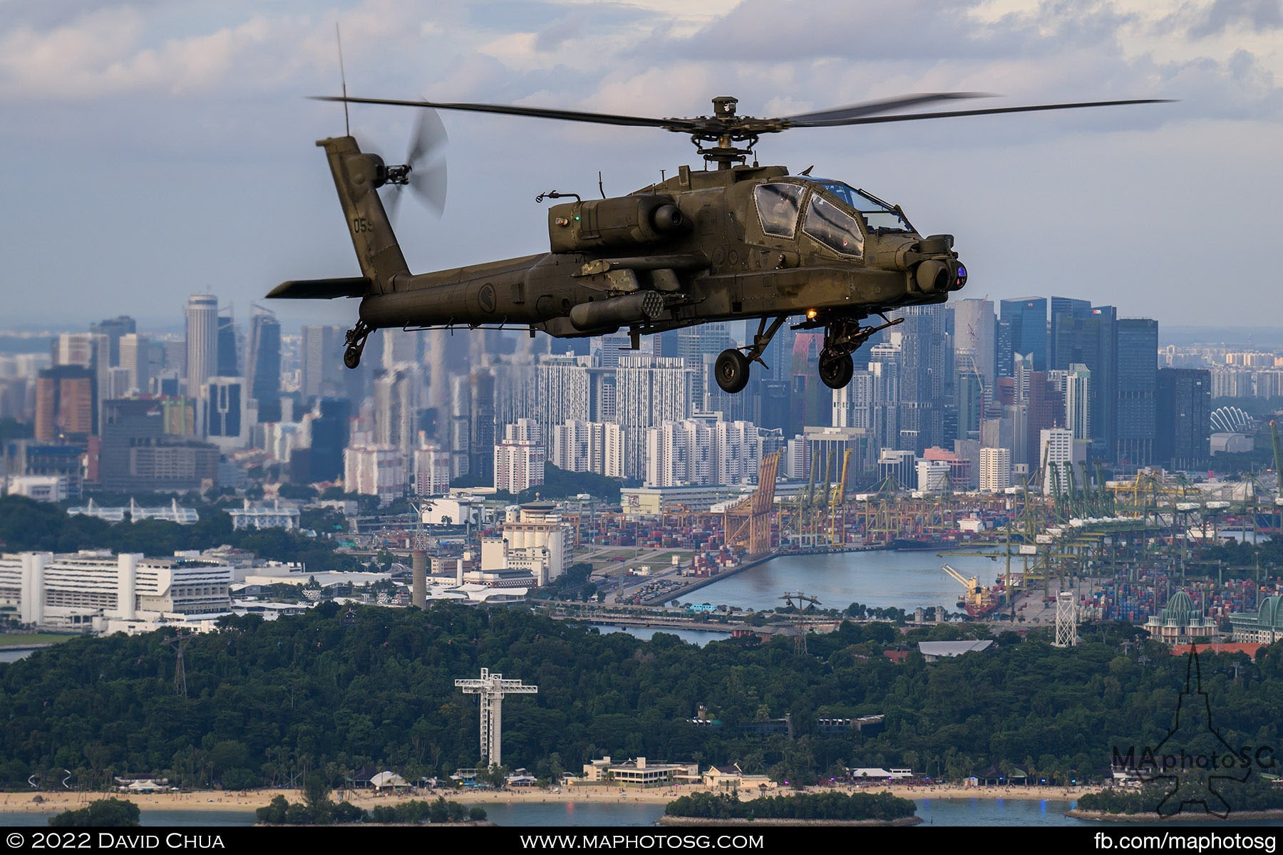 Apache escort of the Chinook as it flies over southern Sentosa