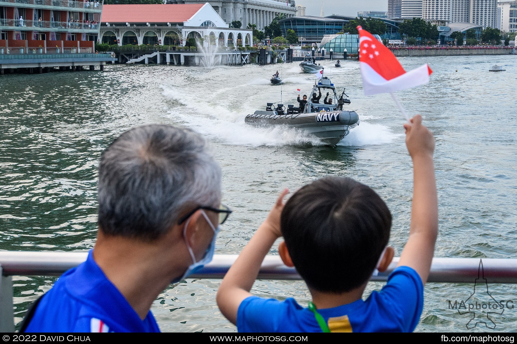 A young fan waves the flag as the Navy servicemen goes around the bay area