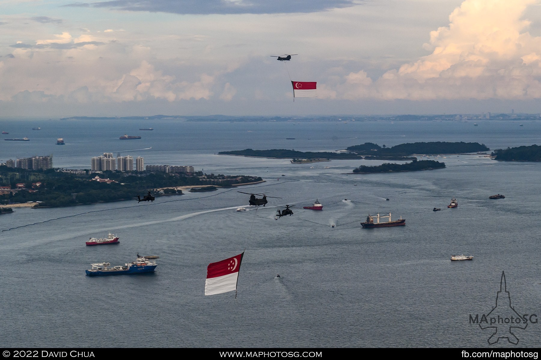 Two Chinook helicopters with state flags holding in the south of Singapore