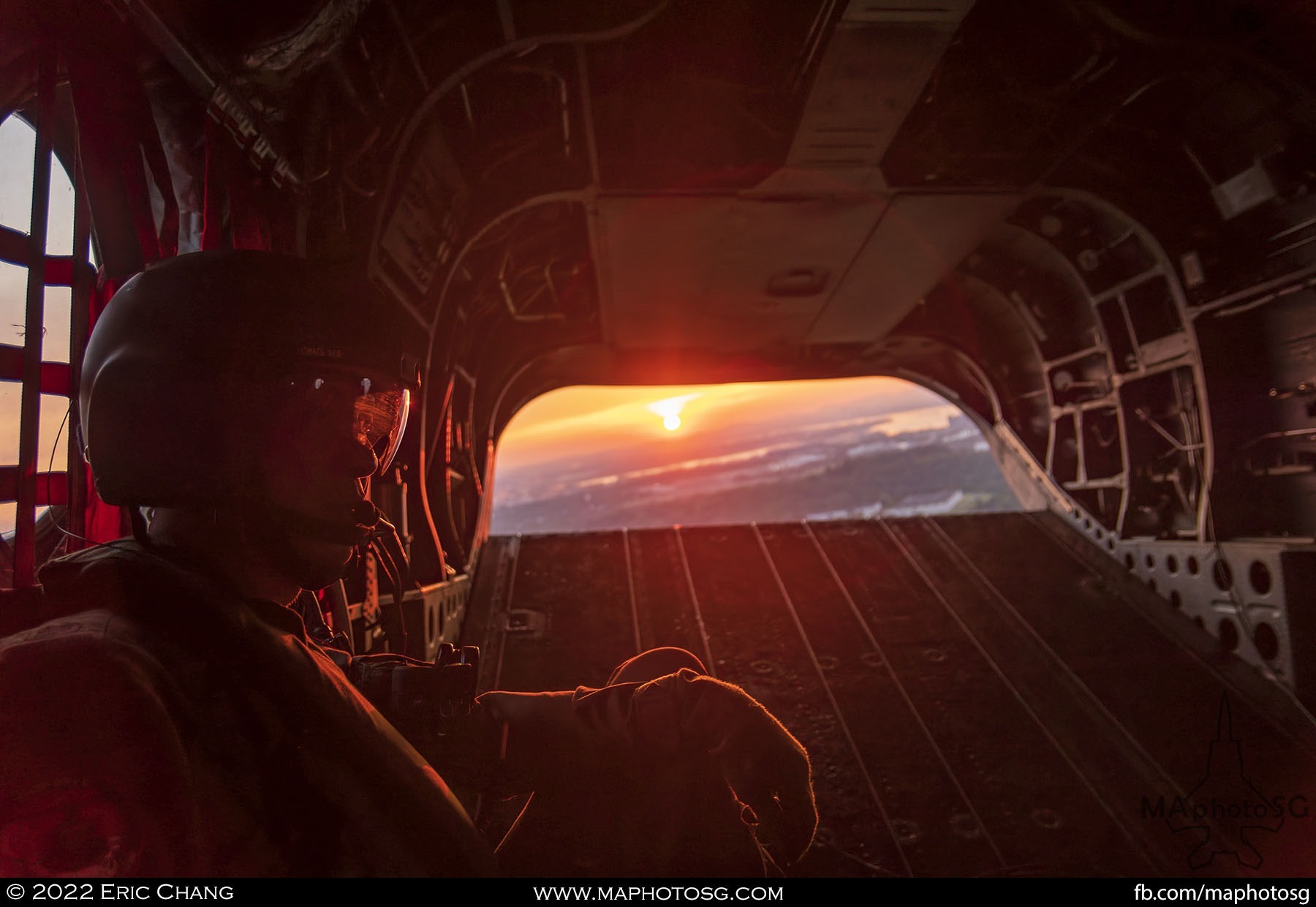 Setting sun peaks through the rear door of the Chinook