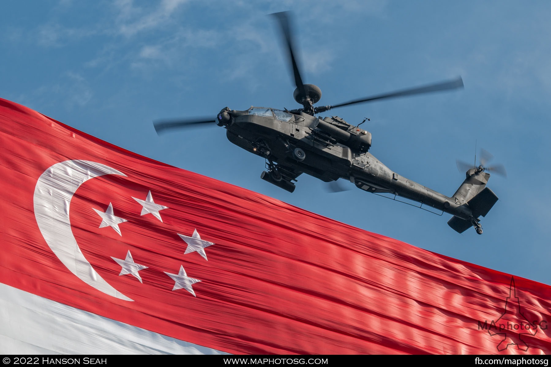 Apache helicopter and the massive state flag hung under the Chinook