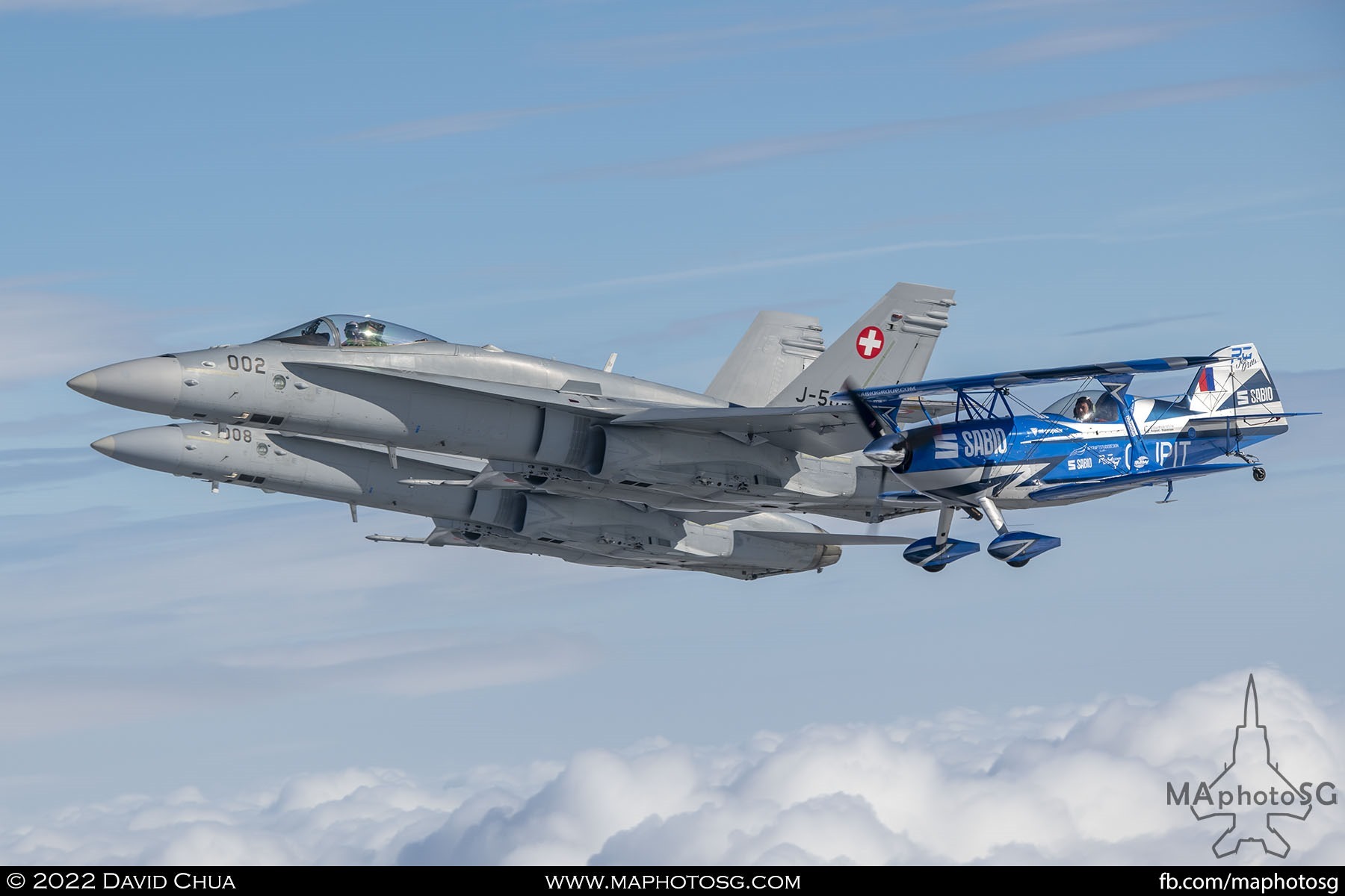 Rich Goodwin Pitts muscle biplane and 2 Swiss Air Force F-18C Hornets in formation