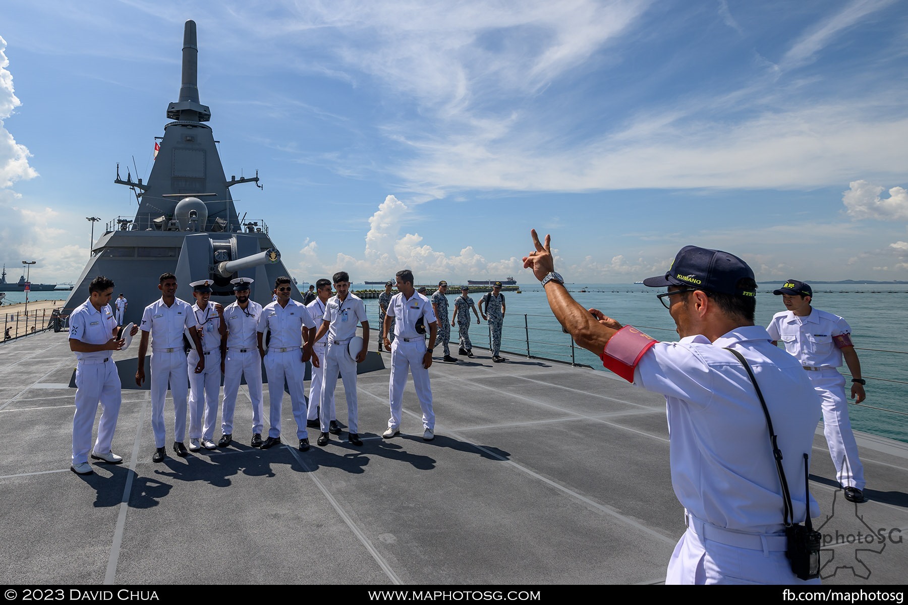 Visiting sailors taking a group photo on the JS Kumano