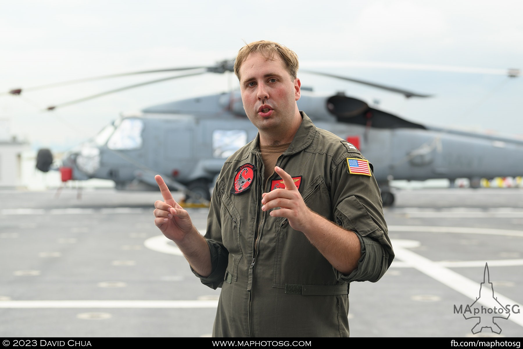 Pilot of the MH-60 Seahawk helicopter explaining about his helicopter on board the USS Mobile (LCS 26)