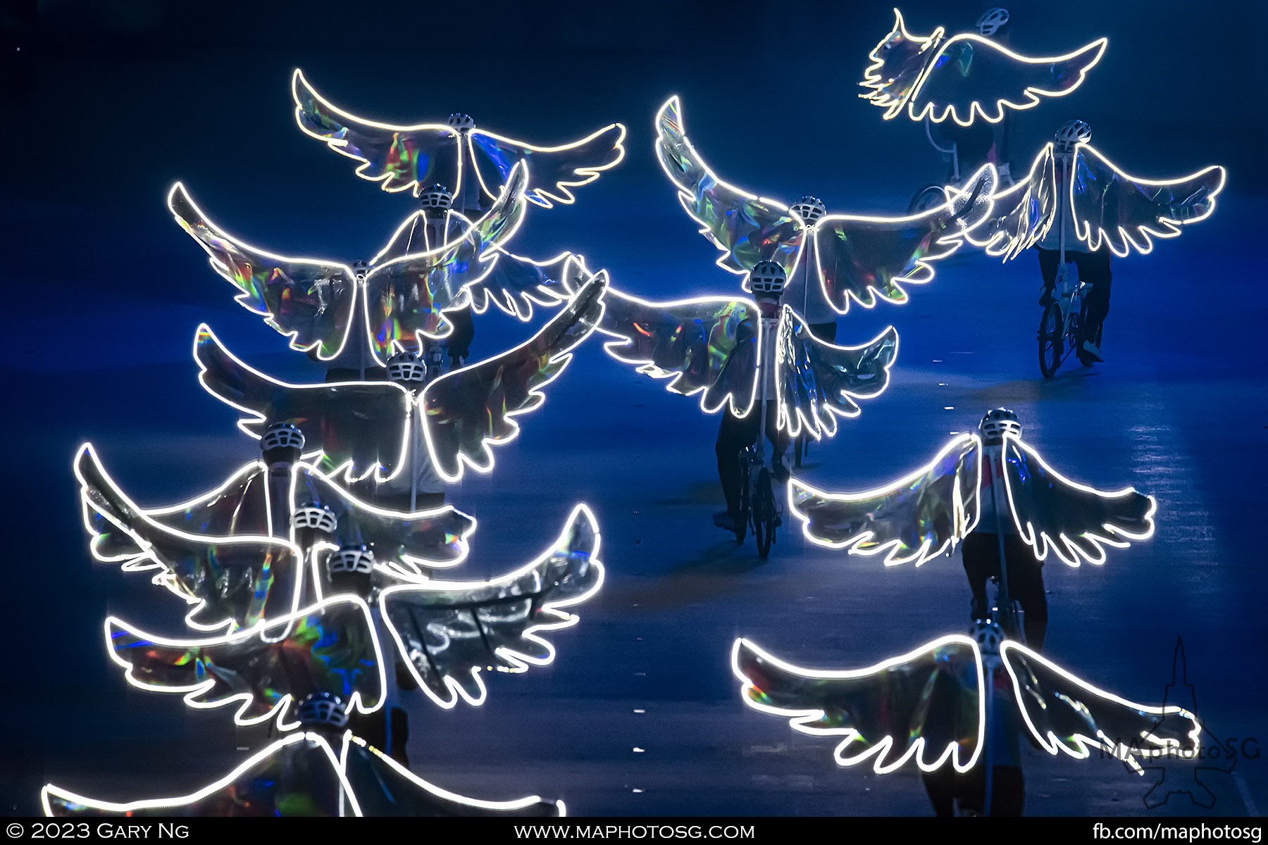 Cyclists from Team Nila Singapore with their lighted wings props portraying doves