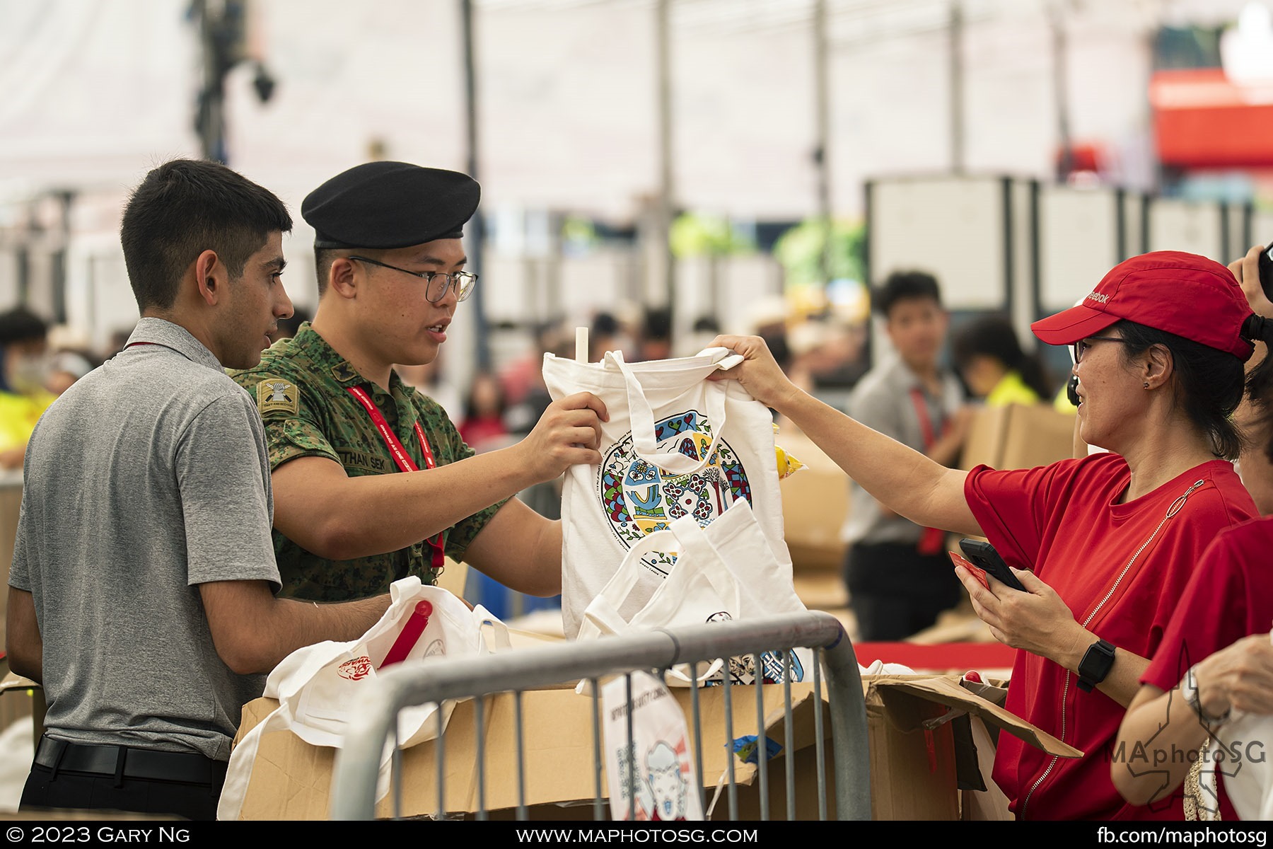 A spectator collecting their NDP 2023 pack