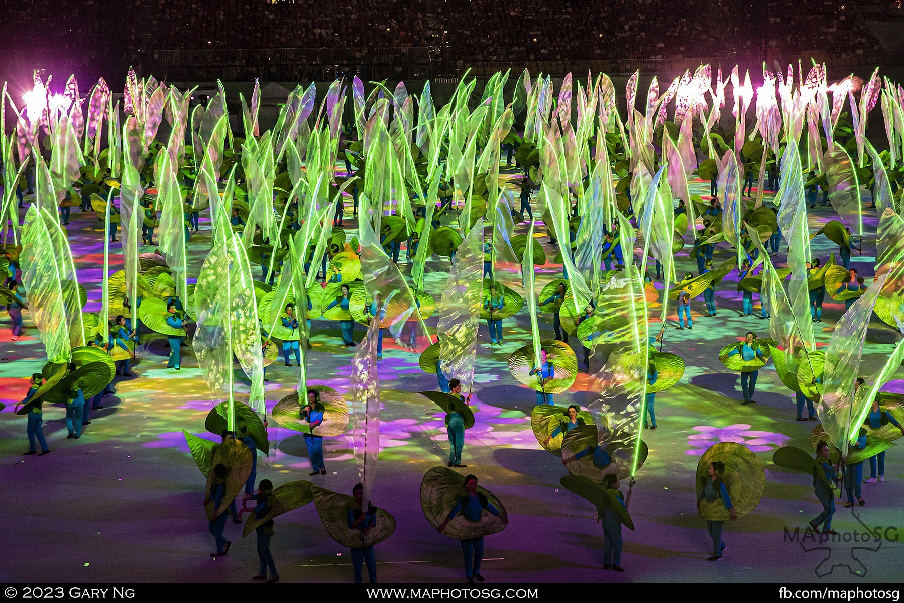 Performers of Act 2 - Our Strength with their tall lighted props representing flowing sprouts